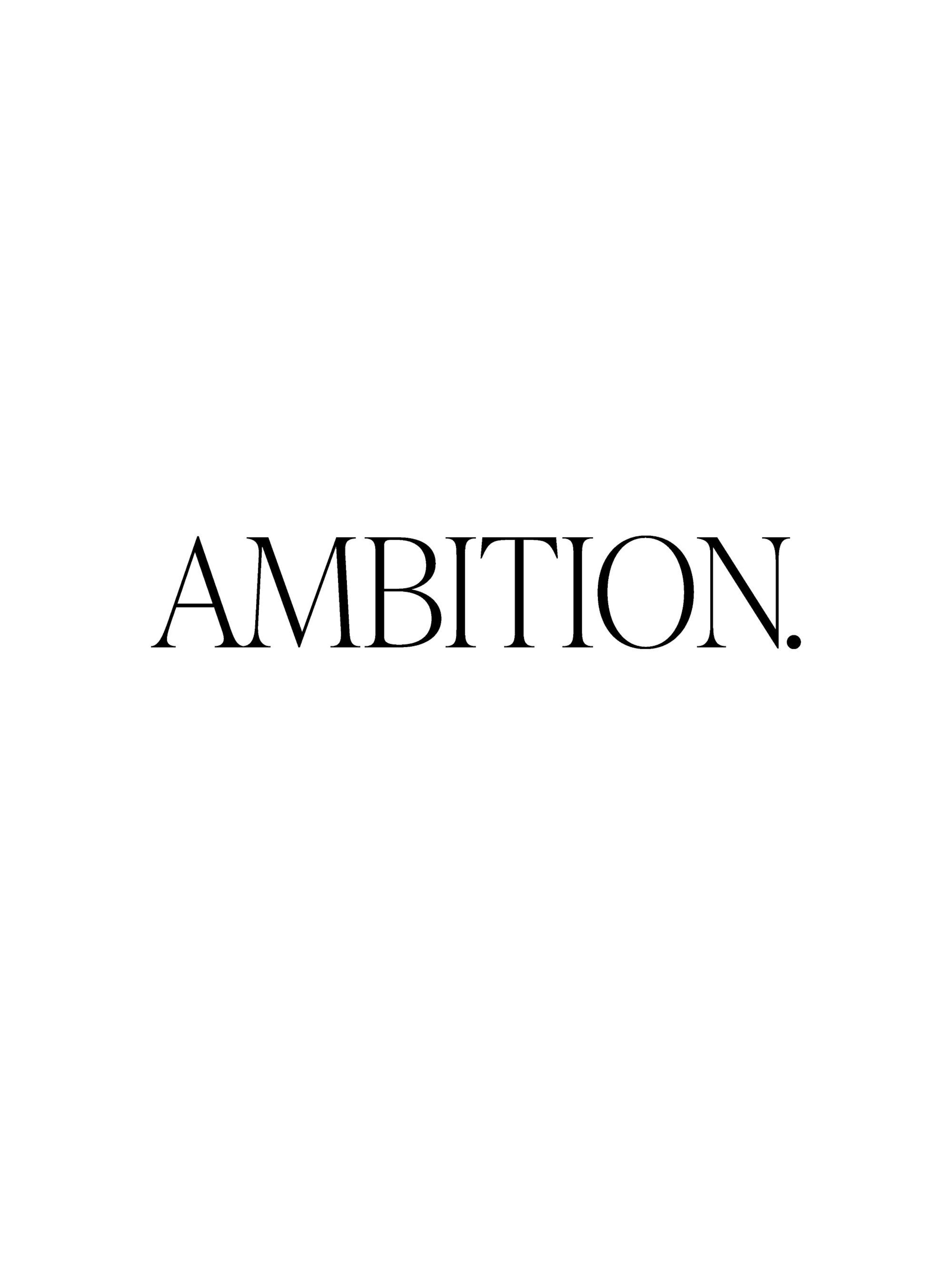 A white poster with the word AMBITION. in black text, hanging above a bedside table with a gold lamp and dried flowers.