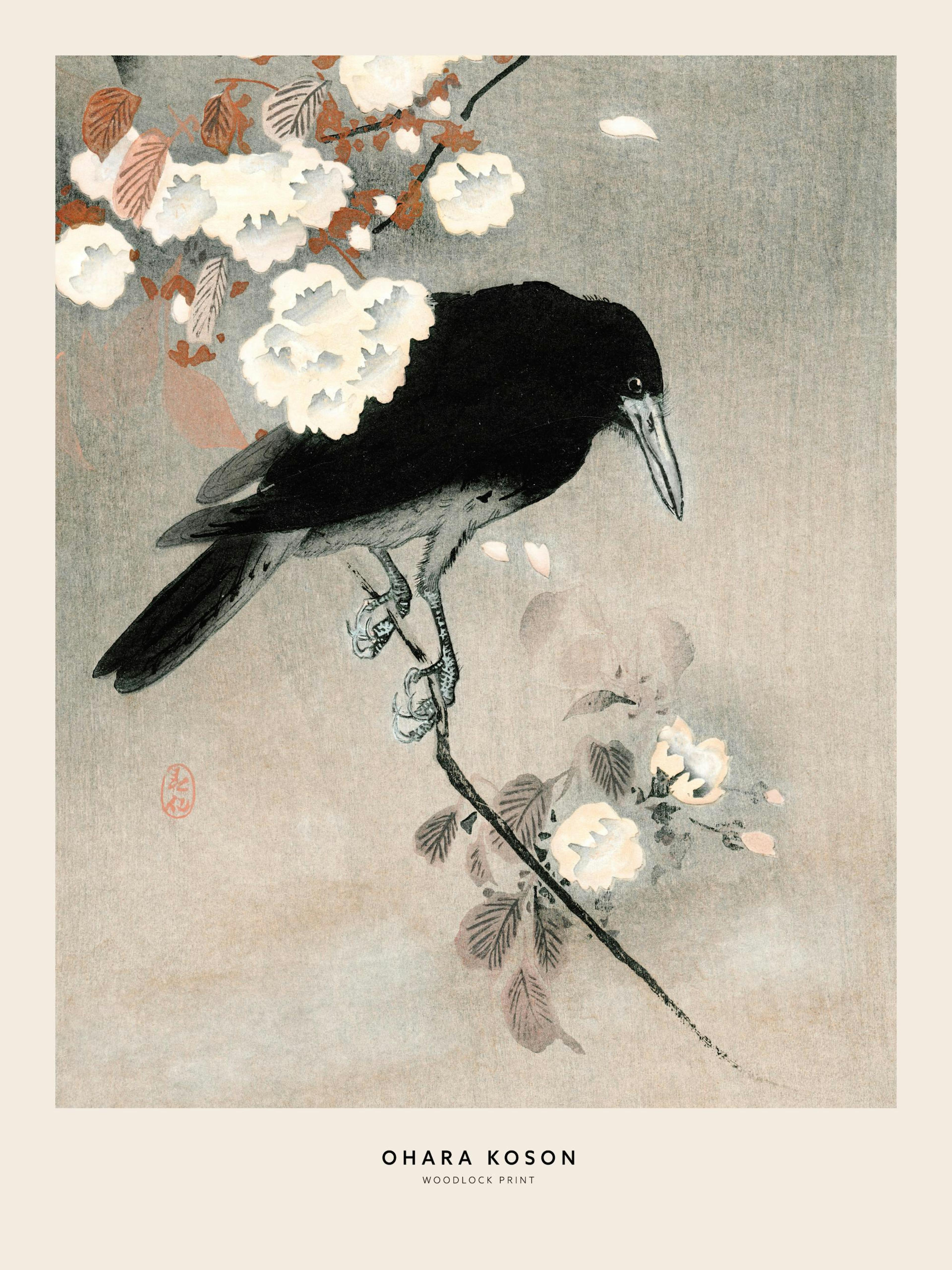 A poster of a black crow on a cherry blossom branch hangs above a dark grey armchair in a modern living room.