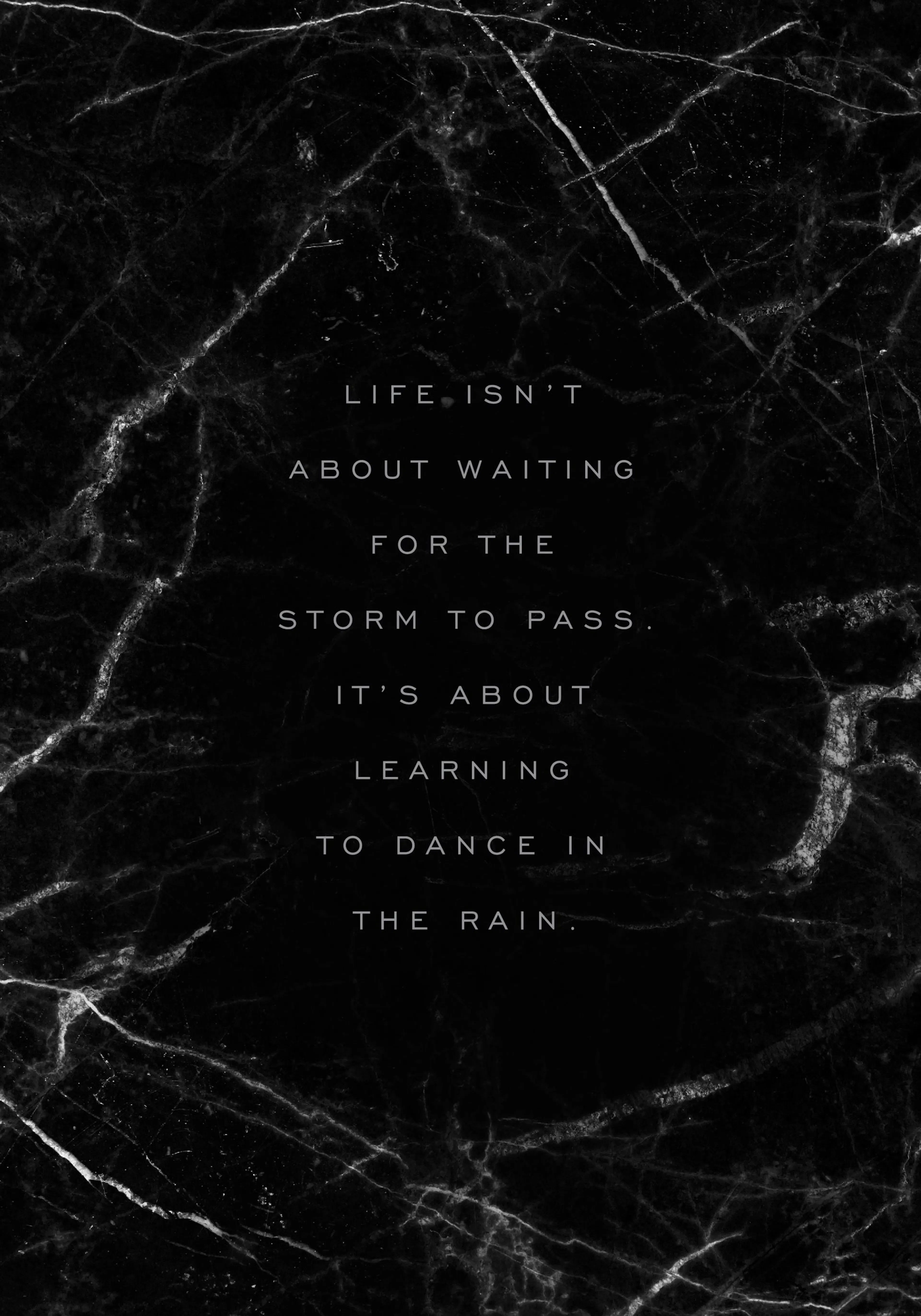 A poster with a black marble background featuring the quote Life isnt about waiting for the storm to pass. Its about learning to