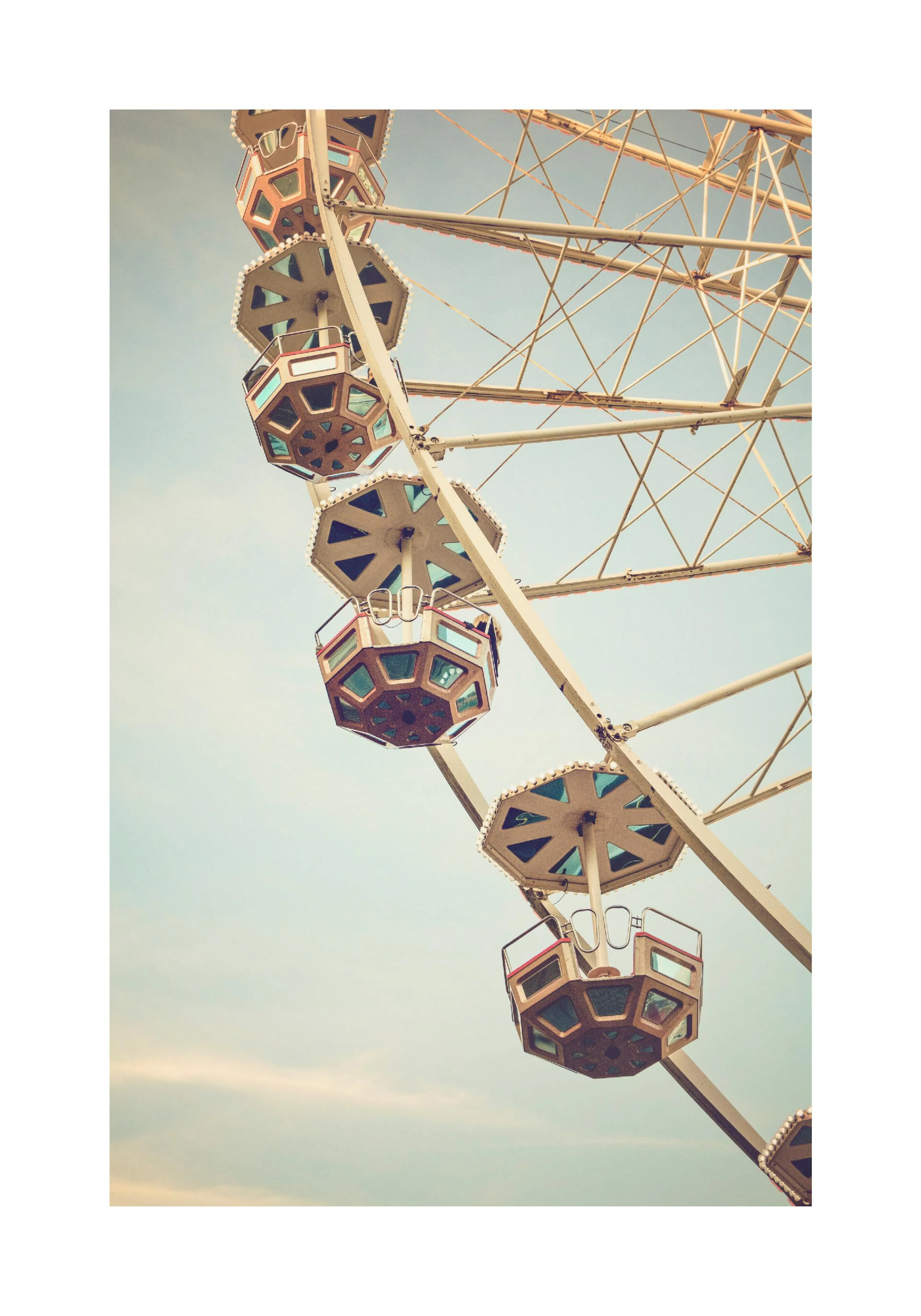 A poster featuring a vintage-style close-up of a Ferris wheel against a clear, light blue sky.