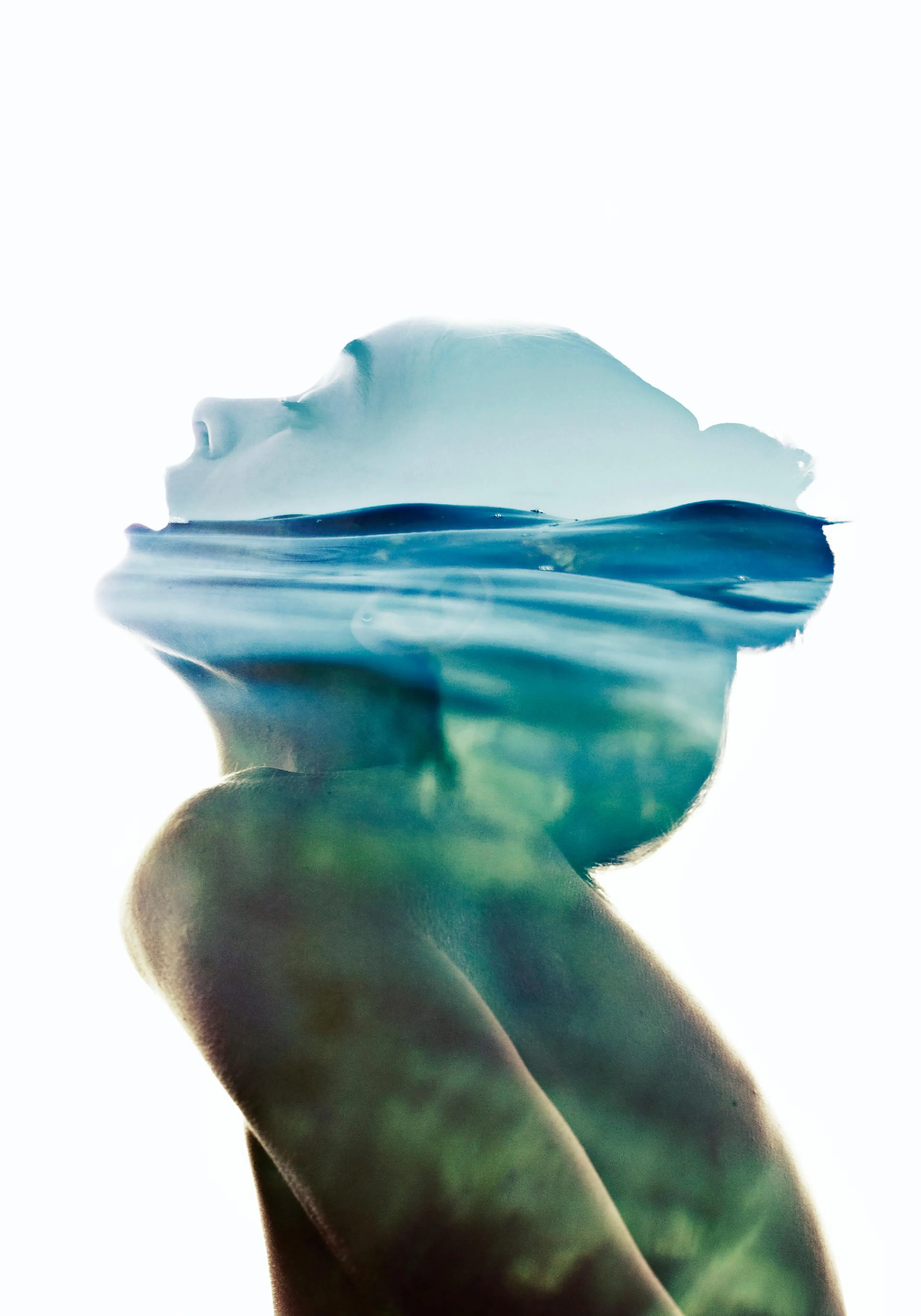 A poster featuring a double exposure of a persons head submerged in water, with blue and green tones.