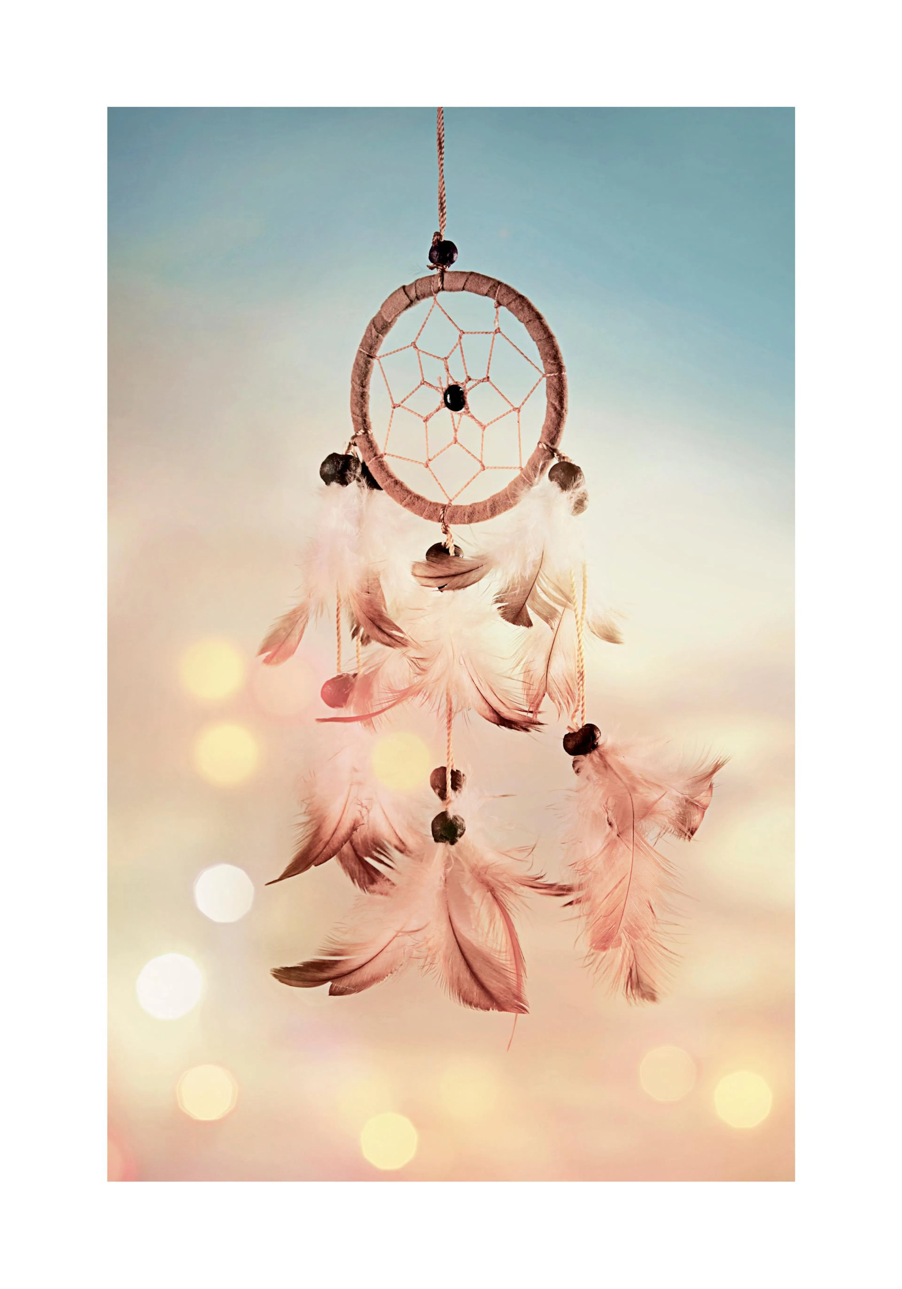 A poster featuring a dream catcher with light brown feathers and beads, set against a soft, bokeh-lit background.