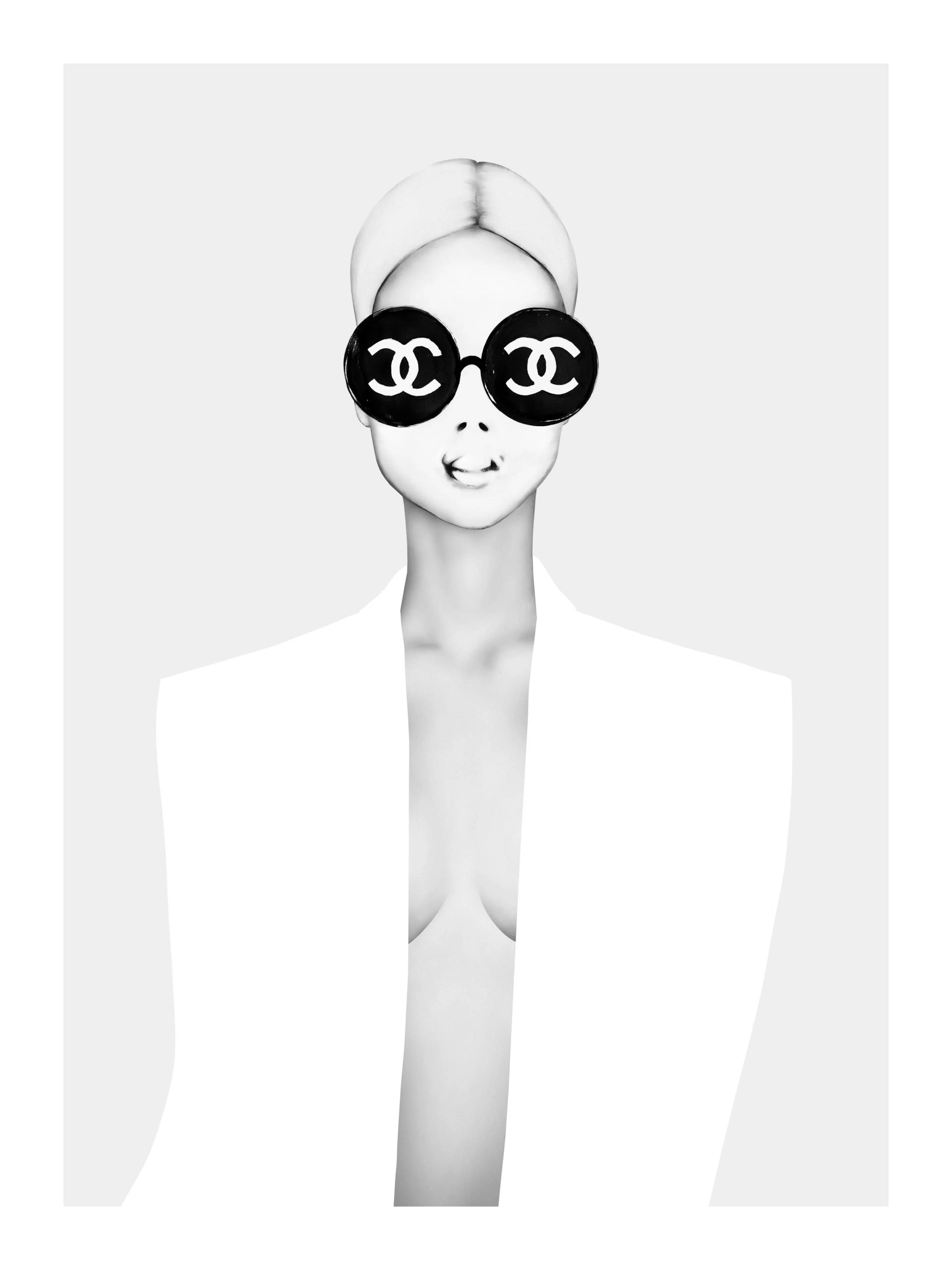 A poster featuring a black and white fashion illustration of a woman wearing large Chanel logo sunglasses.