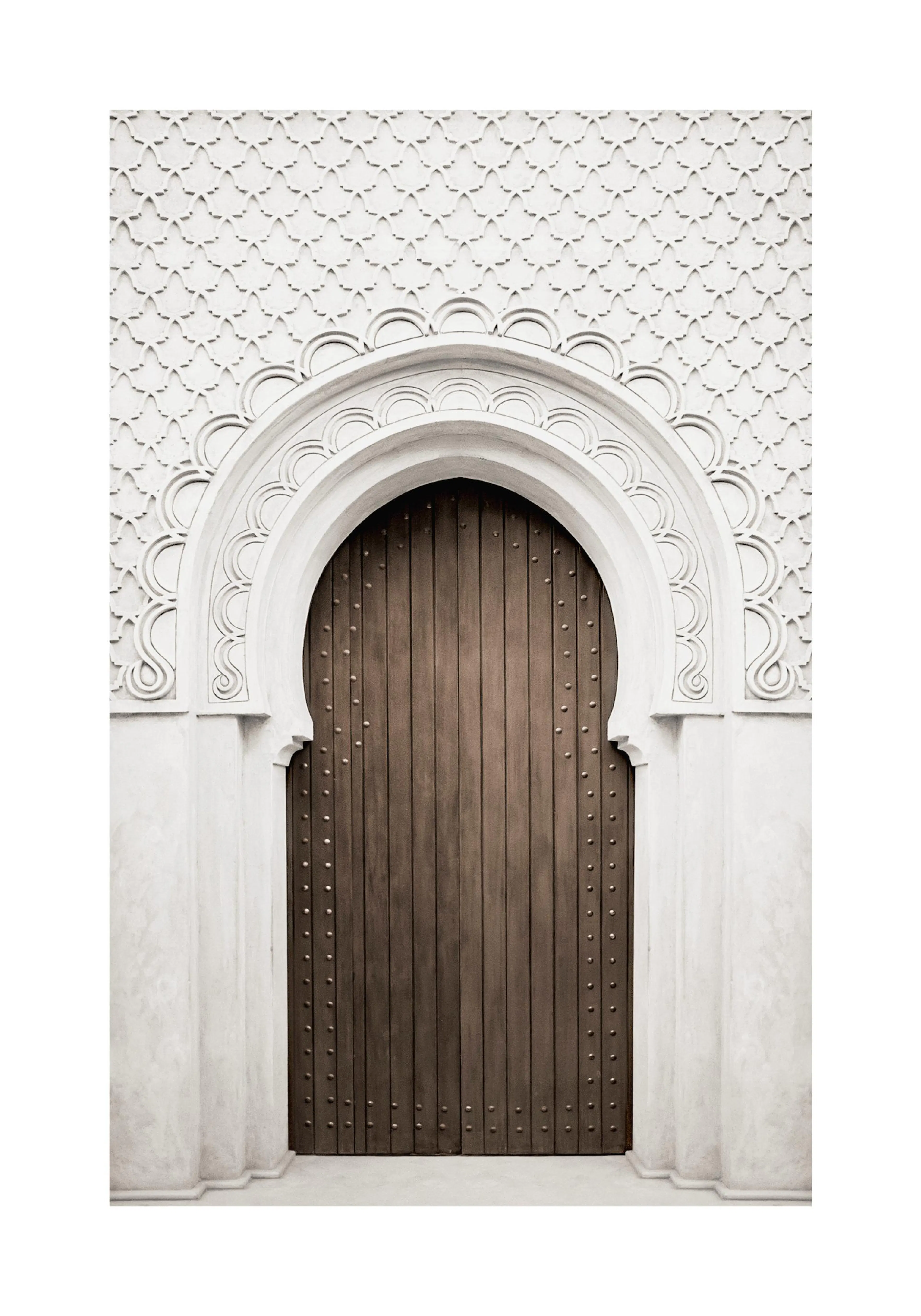 A poster featuring a decorative arched doorway with a rich brown wooden door and intricate white stone carvings.