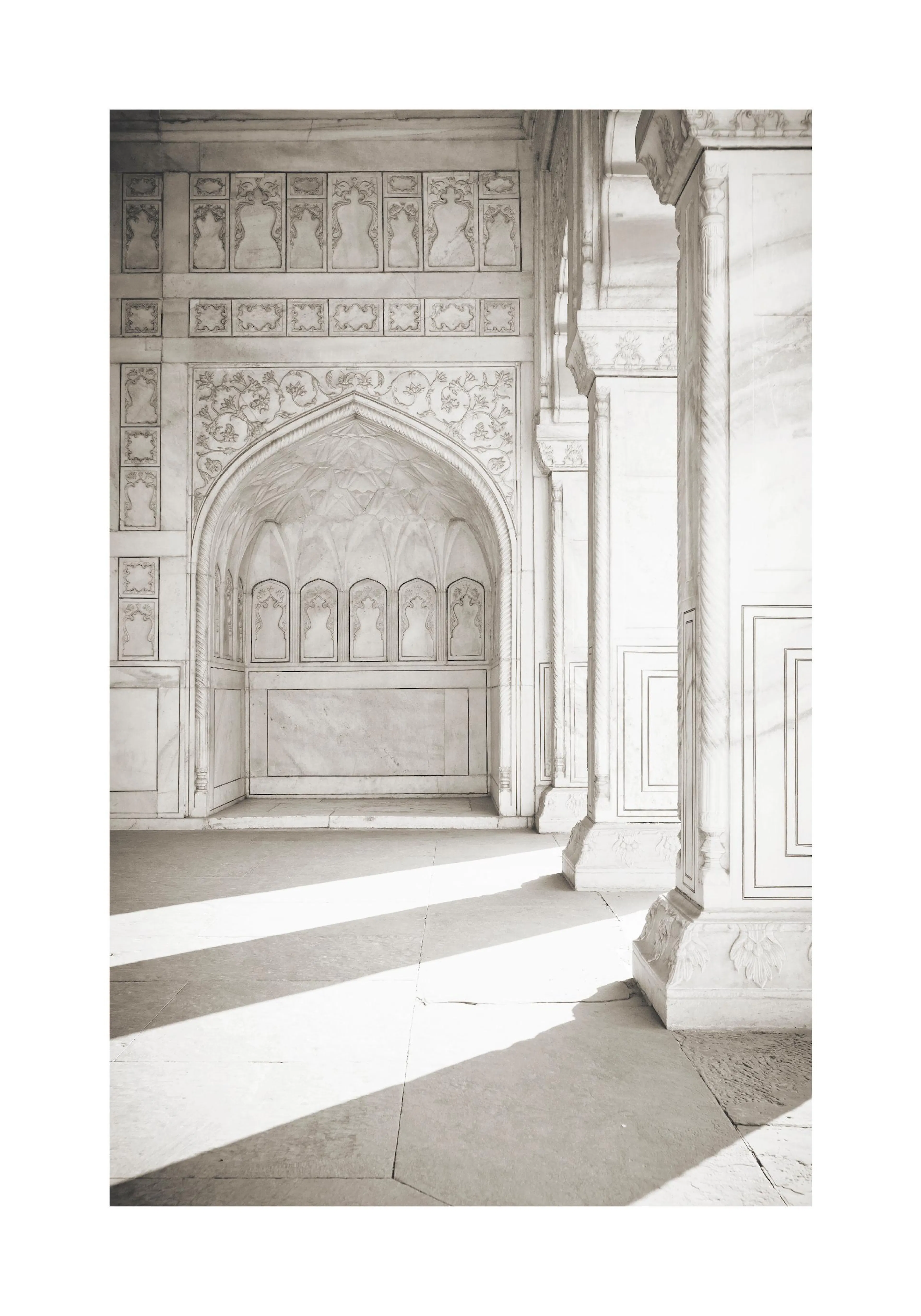 A poster featuring a white marble archway with intricate carvings and elegant columns, illuminated by strong sunlight and shadow