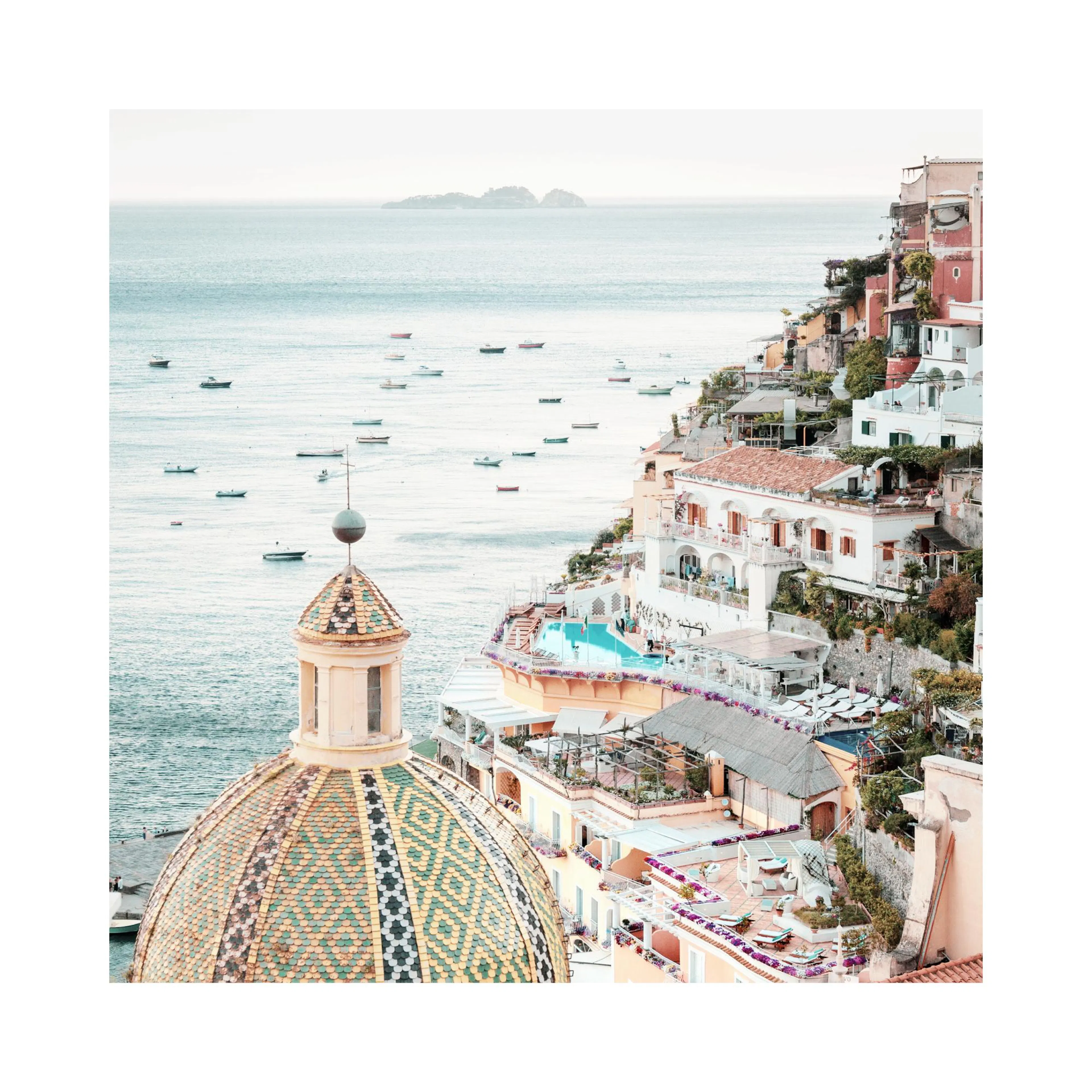 A poster featuring a colorful tiled dome overlooking the vibrant cliffside village of Positano and the sea with boats.