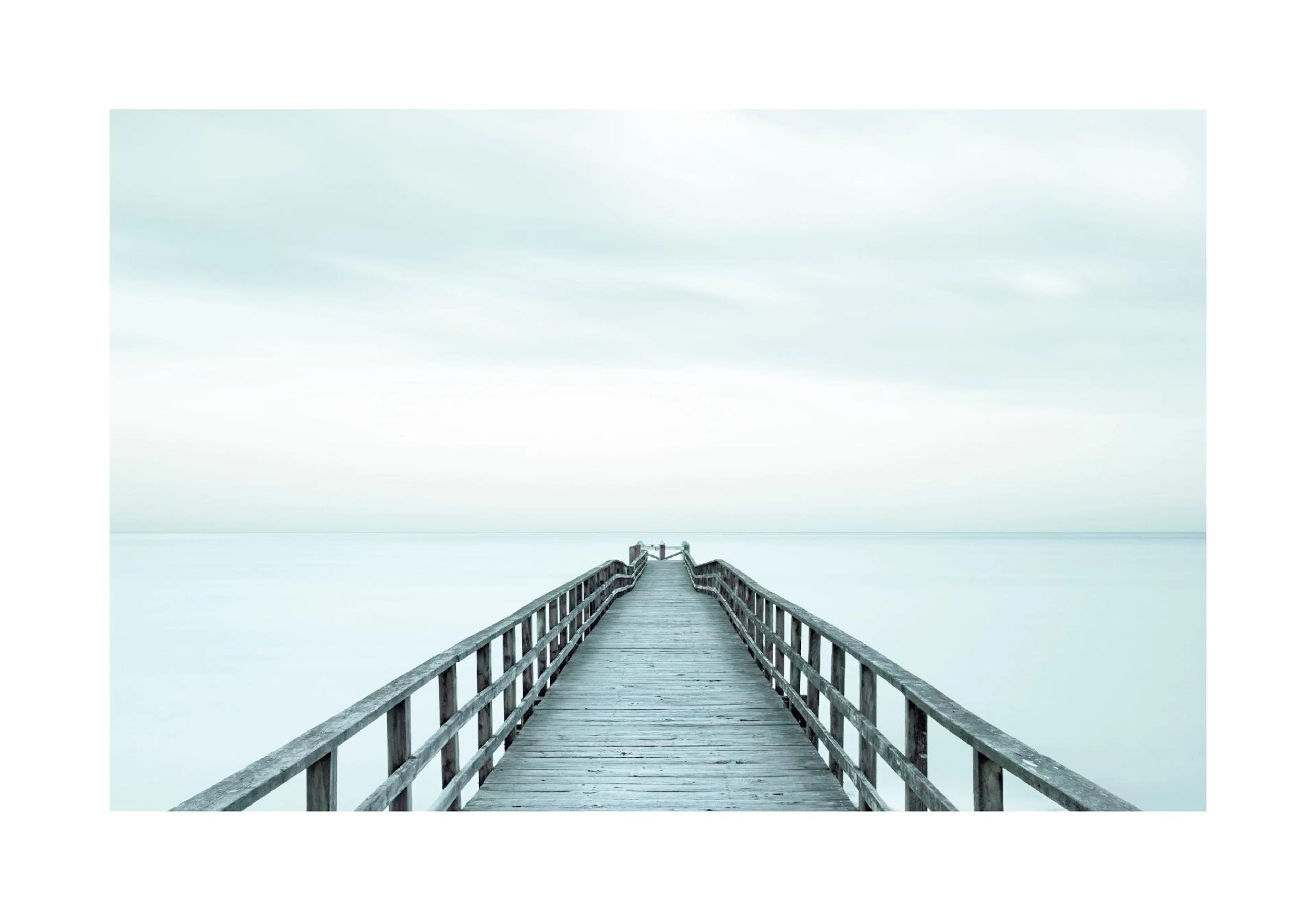 A poster featuring a long wooden jetty extending into a calm, light blue ocean under a pale sky.