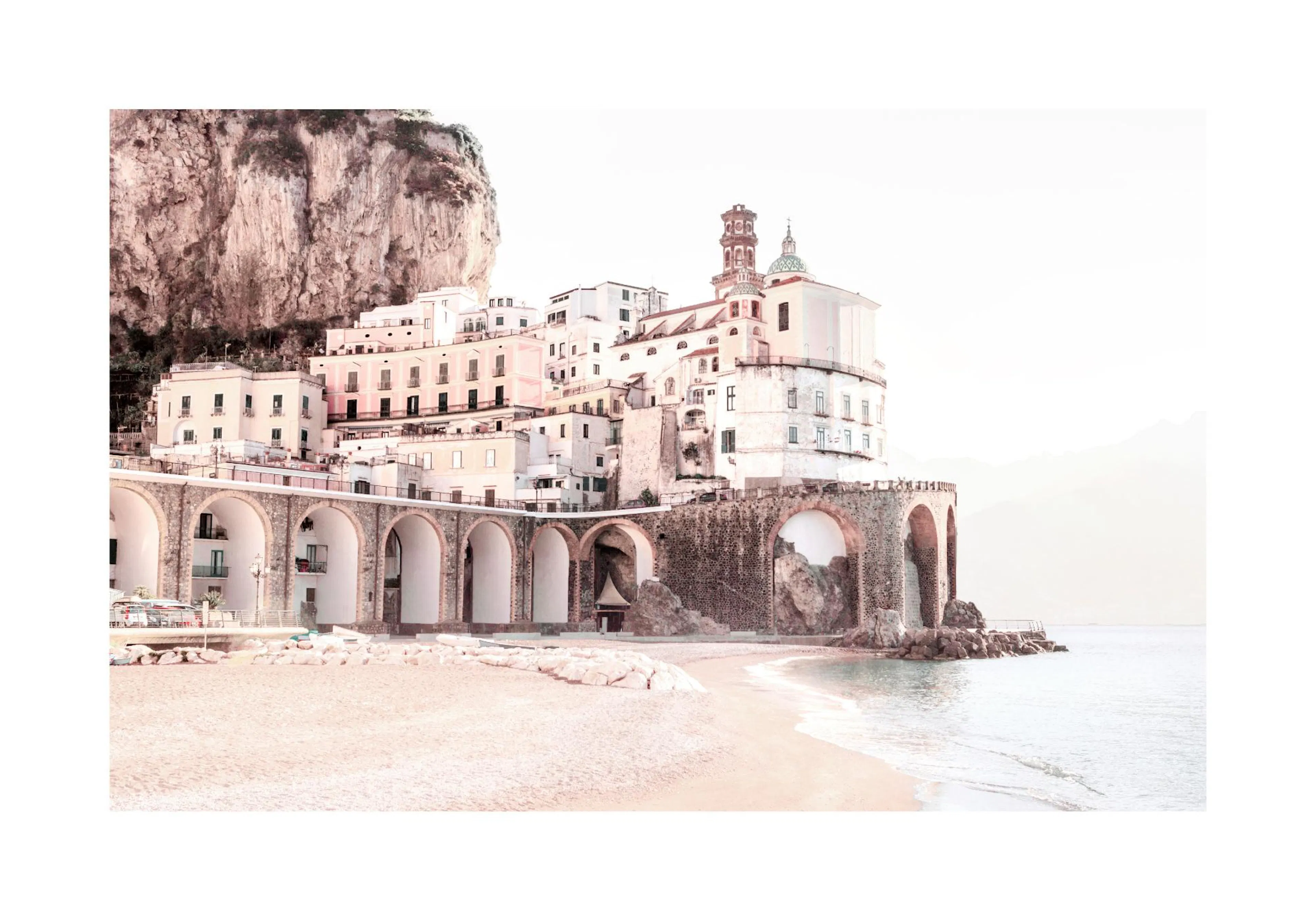 A poster featuring a sun-drenched Amalfi Coast town with white buildings, archways, and a sandy beach by the sea.
