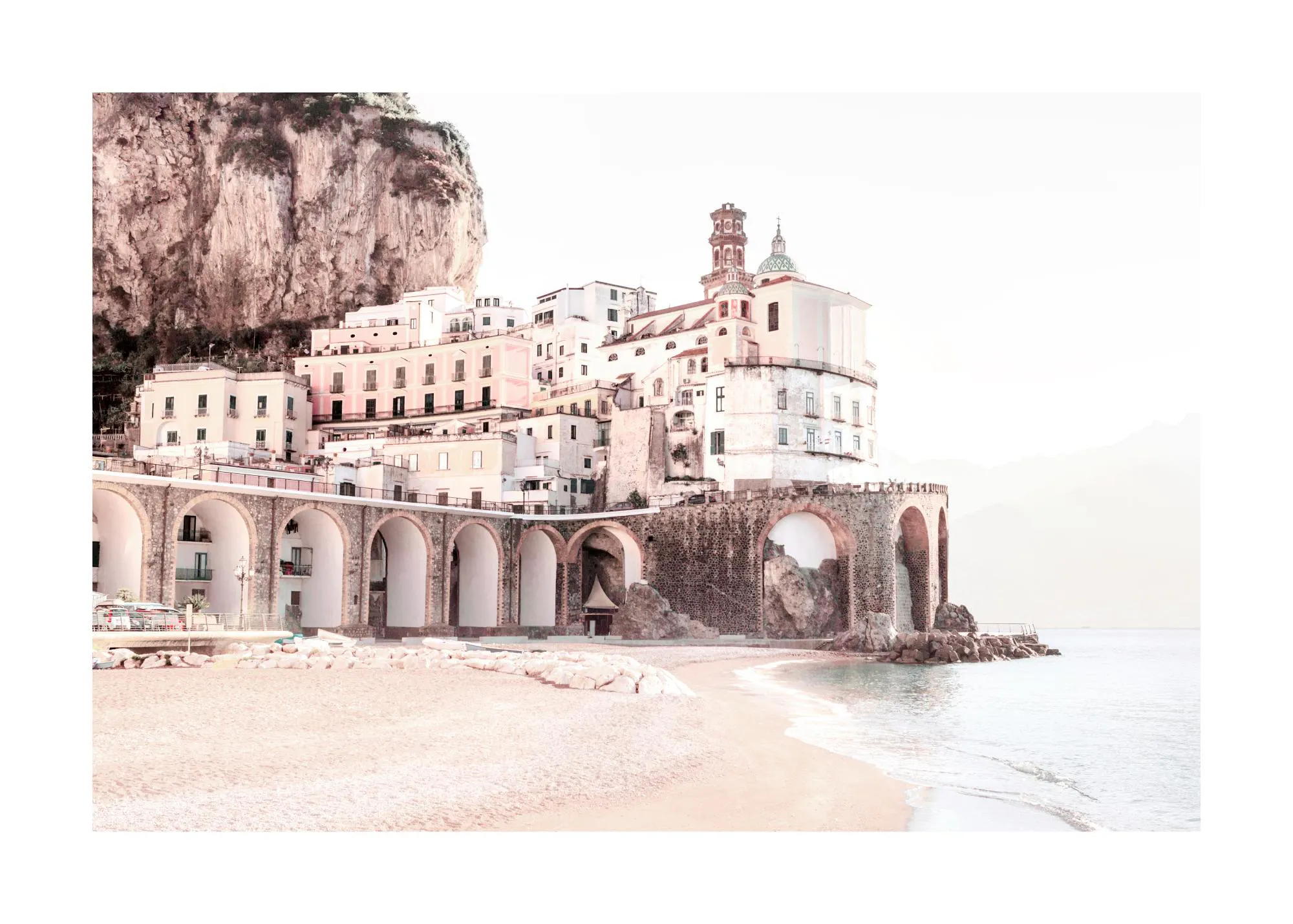 A poster featuring a sun-drenched Amalfi Coast town with white buildings, archways, and a sandy beach by the sea.