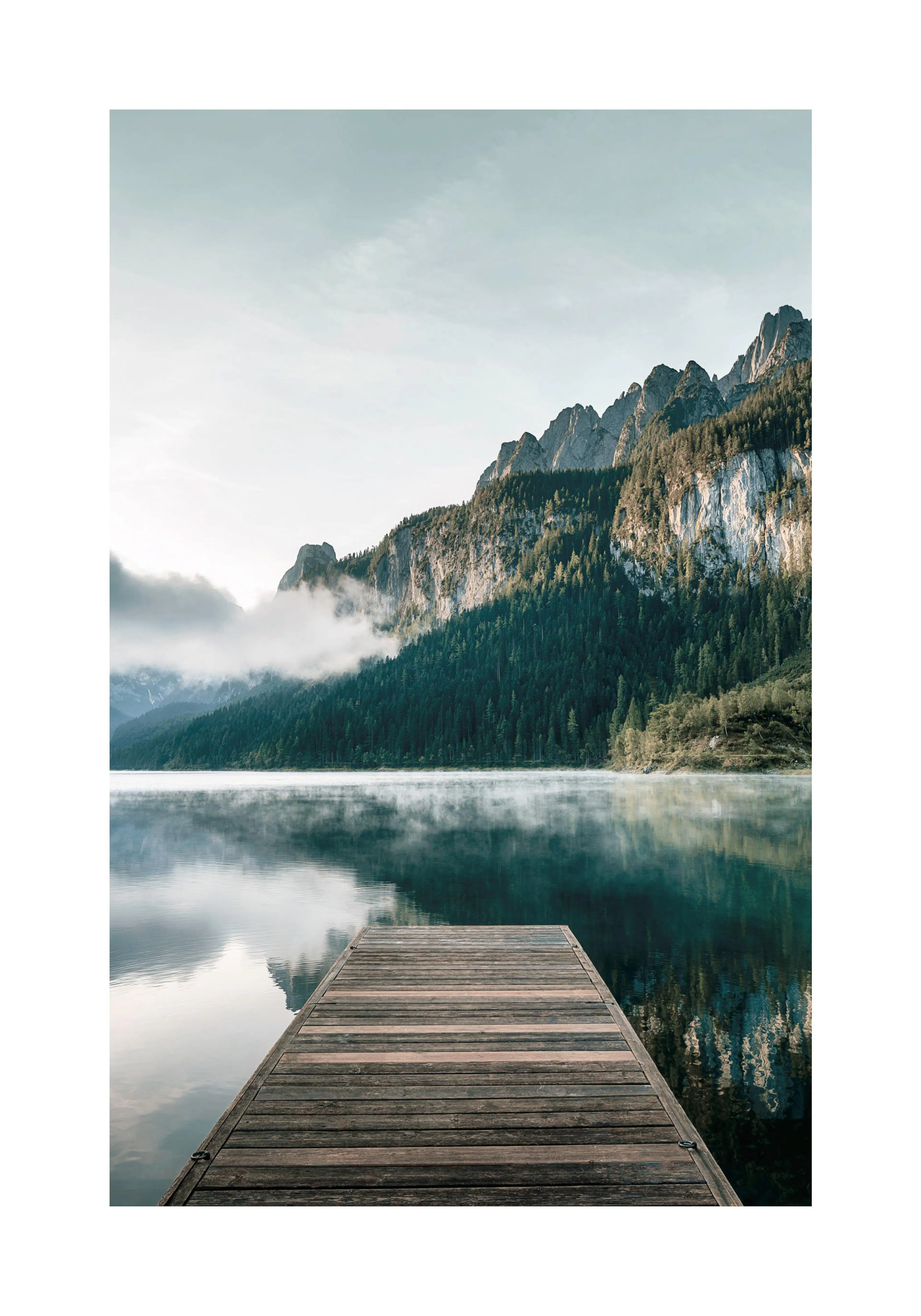 A poster featuring a wooden pier extending into a misty lake, with lush green mountains reflecting on the calm water.