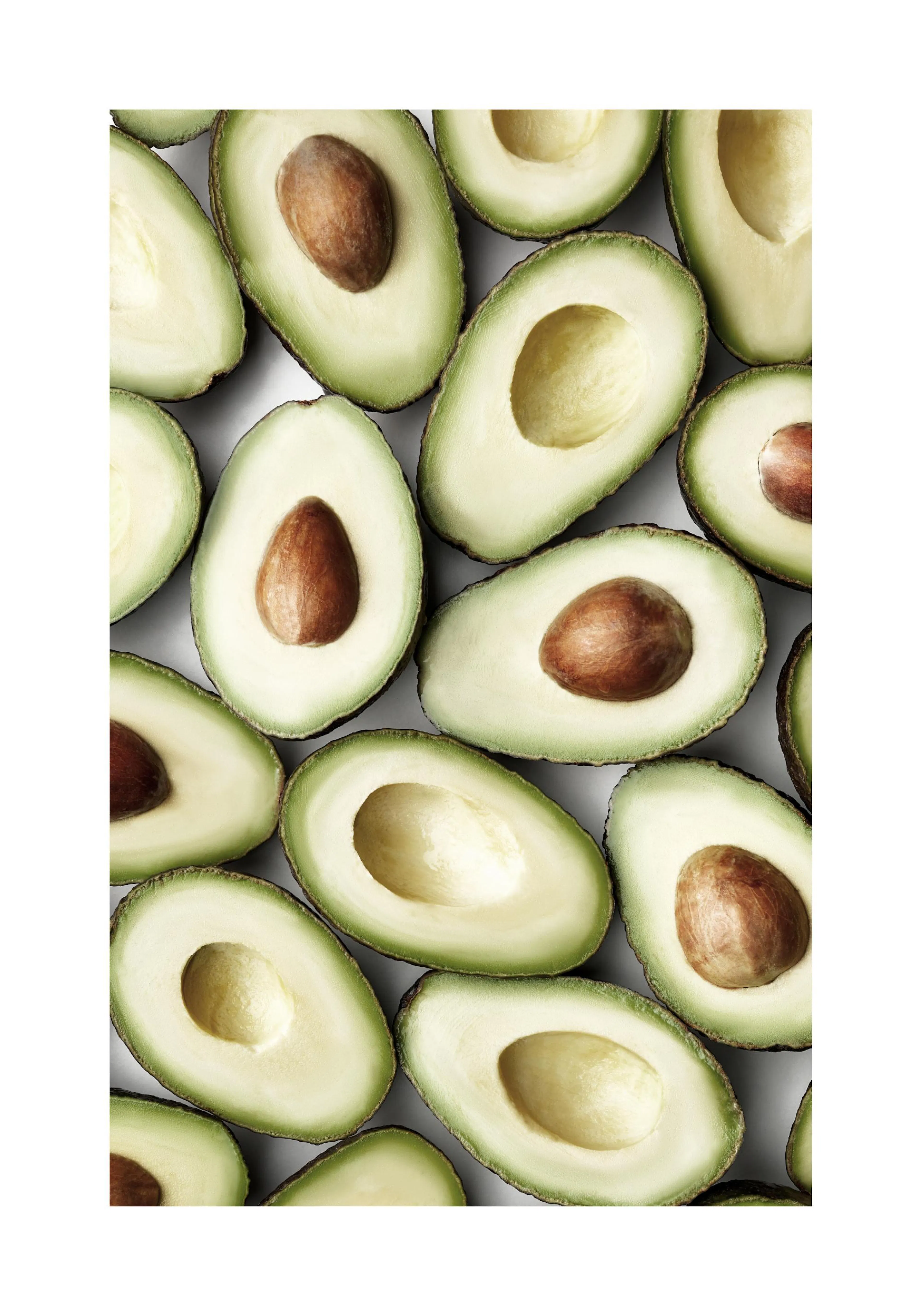 A poster featuring a top-down view of many halved avocados, some with pits, on a white background.