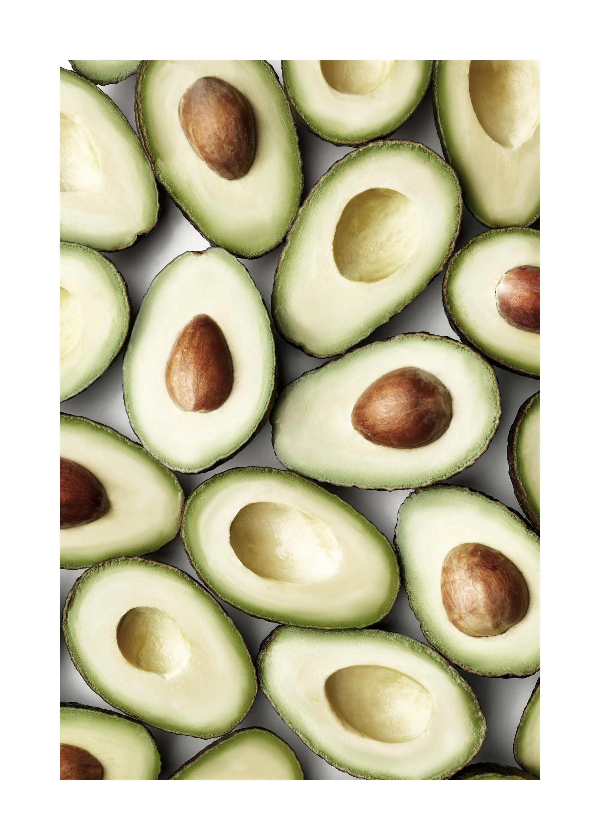 A poster featuring a close-up, top-down view of many fresh avocados cut in half, some with pits, on a light background.
