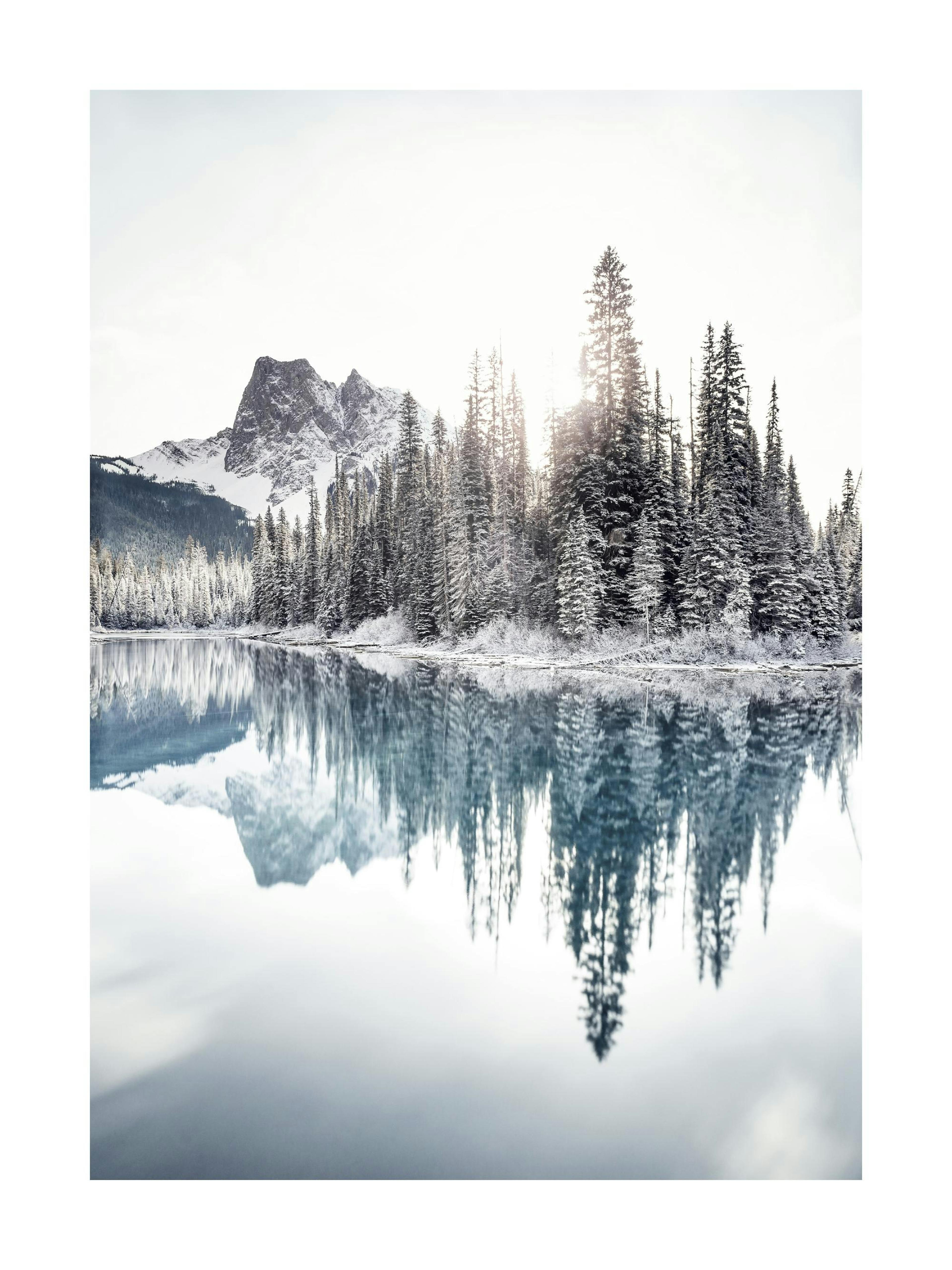 A poster featuring a snow-covered mountain and evergreen trees reflecting in a tranquil, light blue lake under a bright sky.
