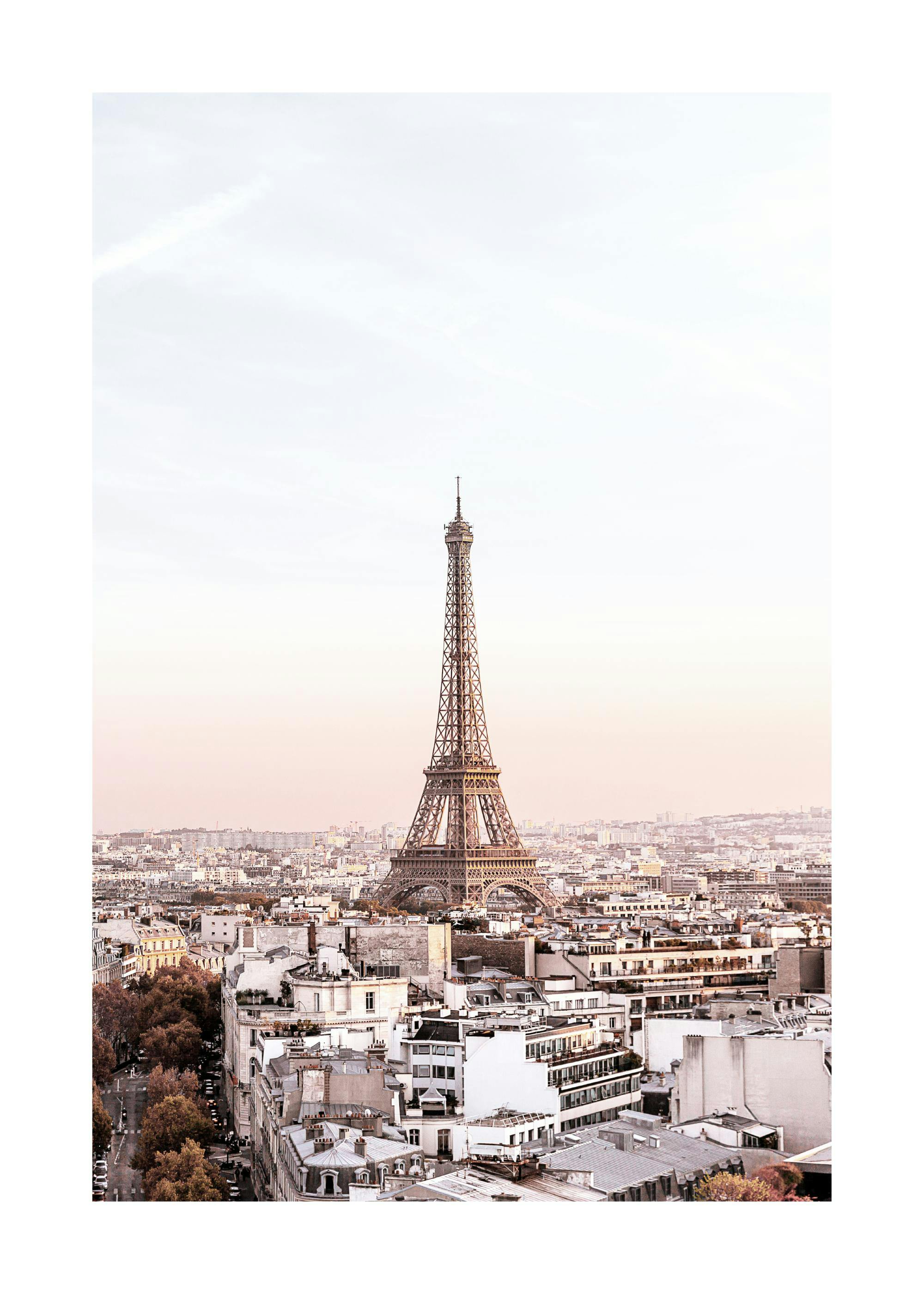 Un poster cu Turnul Eiffel dominând orizontul Parisului, înconjurat de clădiri clasice și un cer rozaliu la apus.
