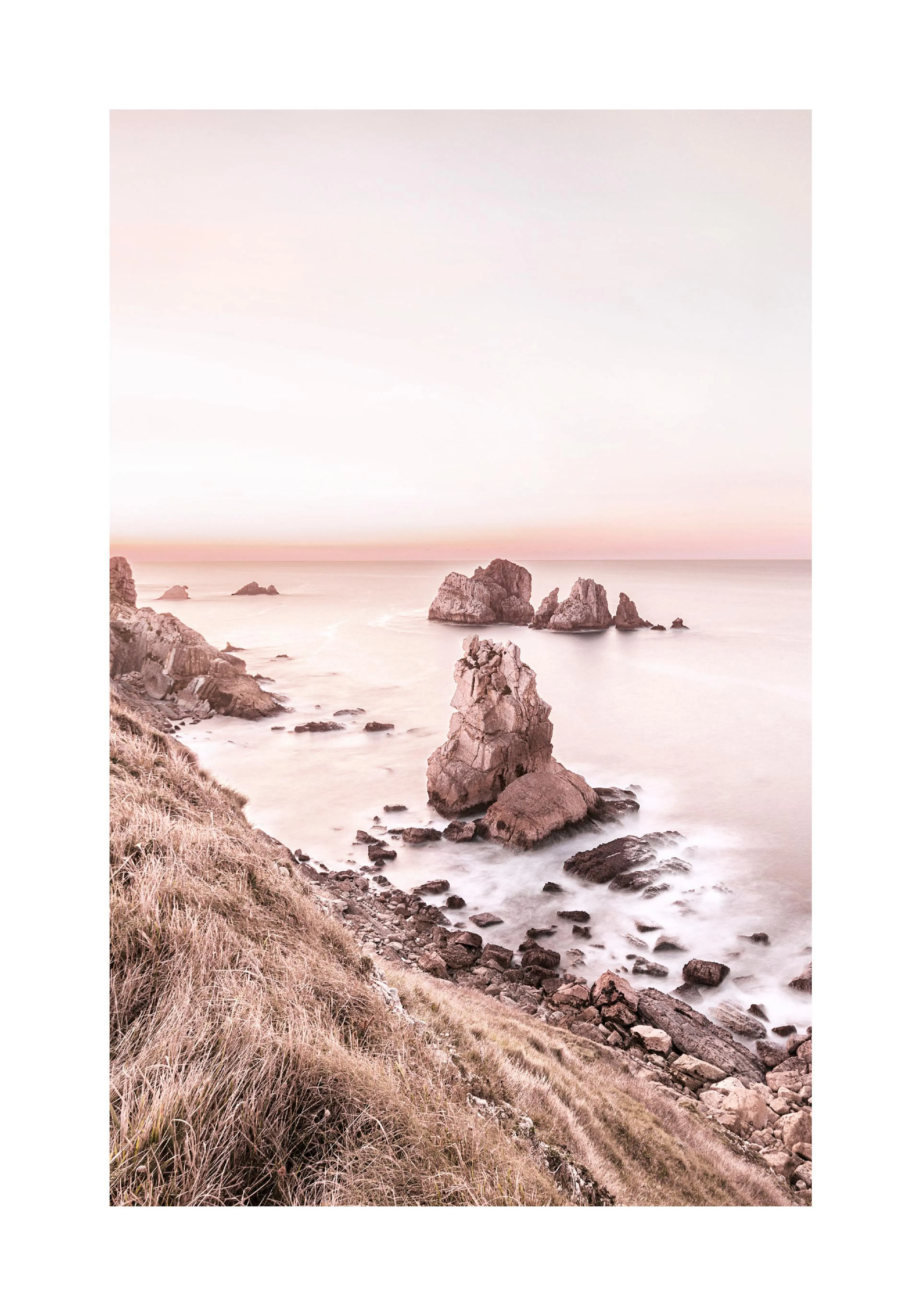 A poster featuring a coastal landscape at sunset, with rocky outcrops in the ocean and a grassy cliff in the foreground.
