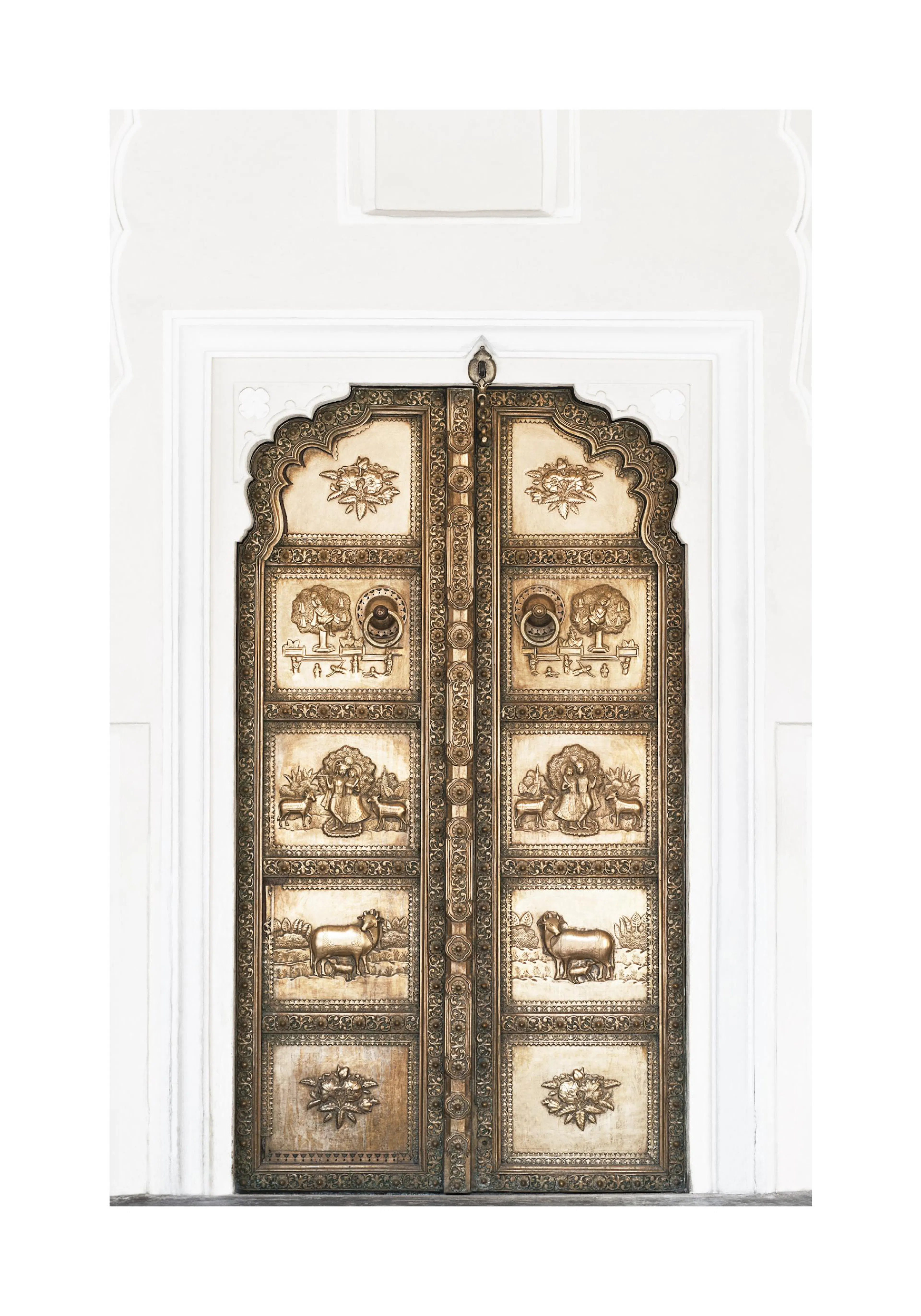 A poster of an ancient Indian temple door, featuring intricate carvings of elephants, people, and animals in a gold and bronze f
