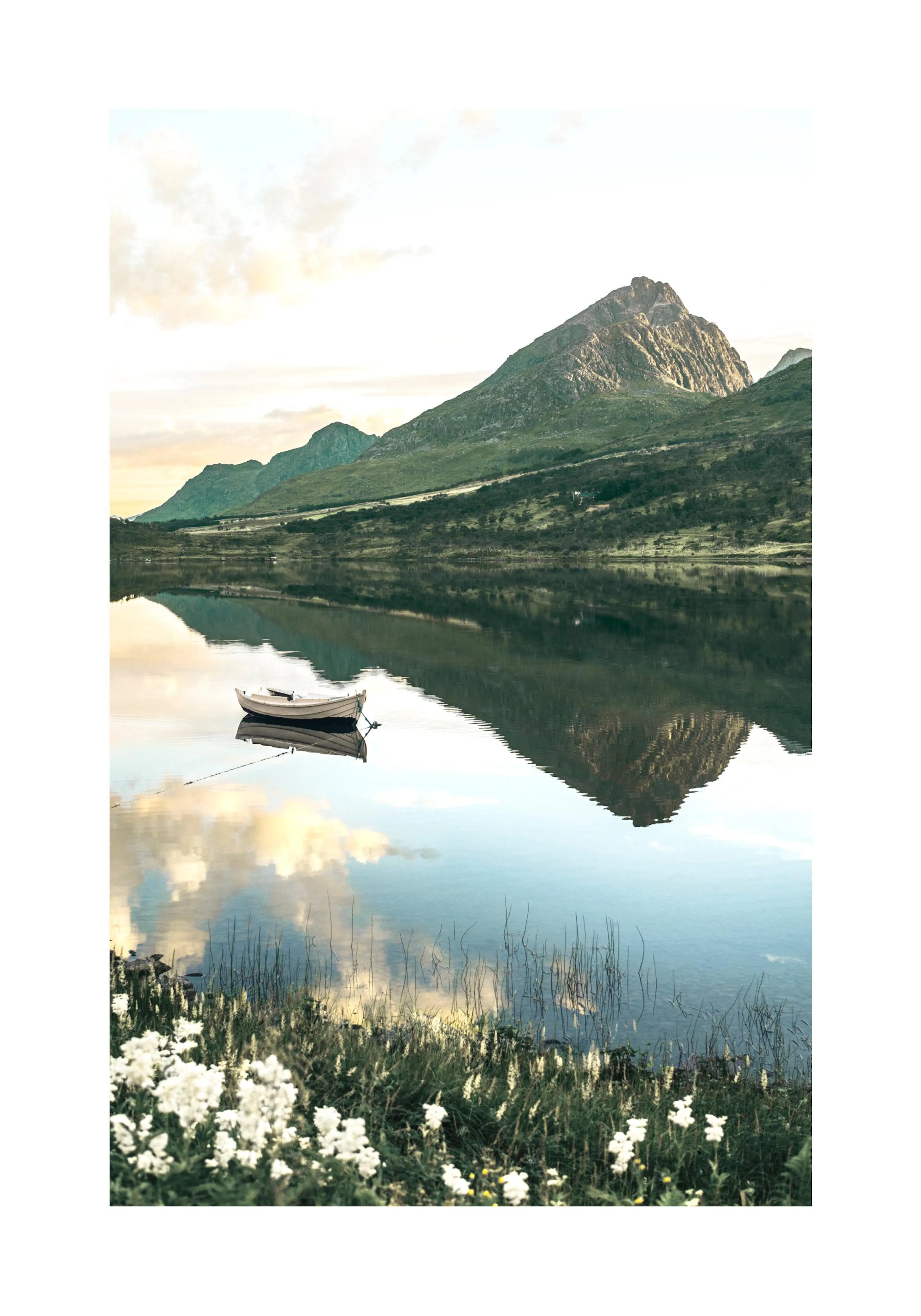 A poster featuring a boat on a calm lake reflecting mountains and sky, with white flowers and grass in the foreground.