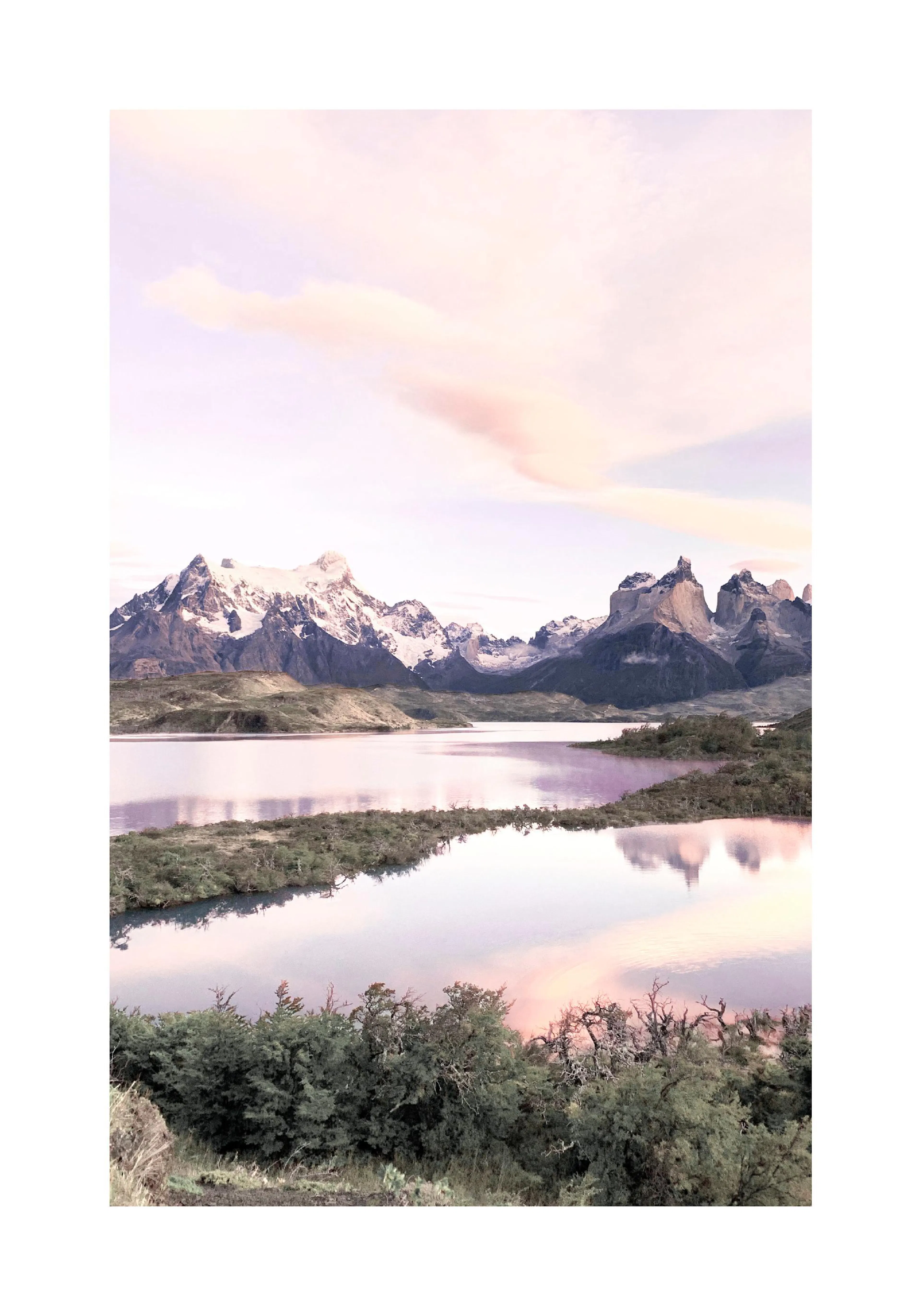 A poster featuring a tranquil lake reflecting snowy mountains and a soft pink sky at sunset, with green foliage in the foregroun