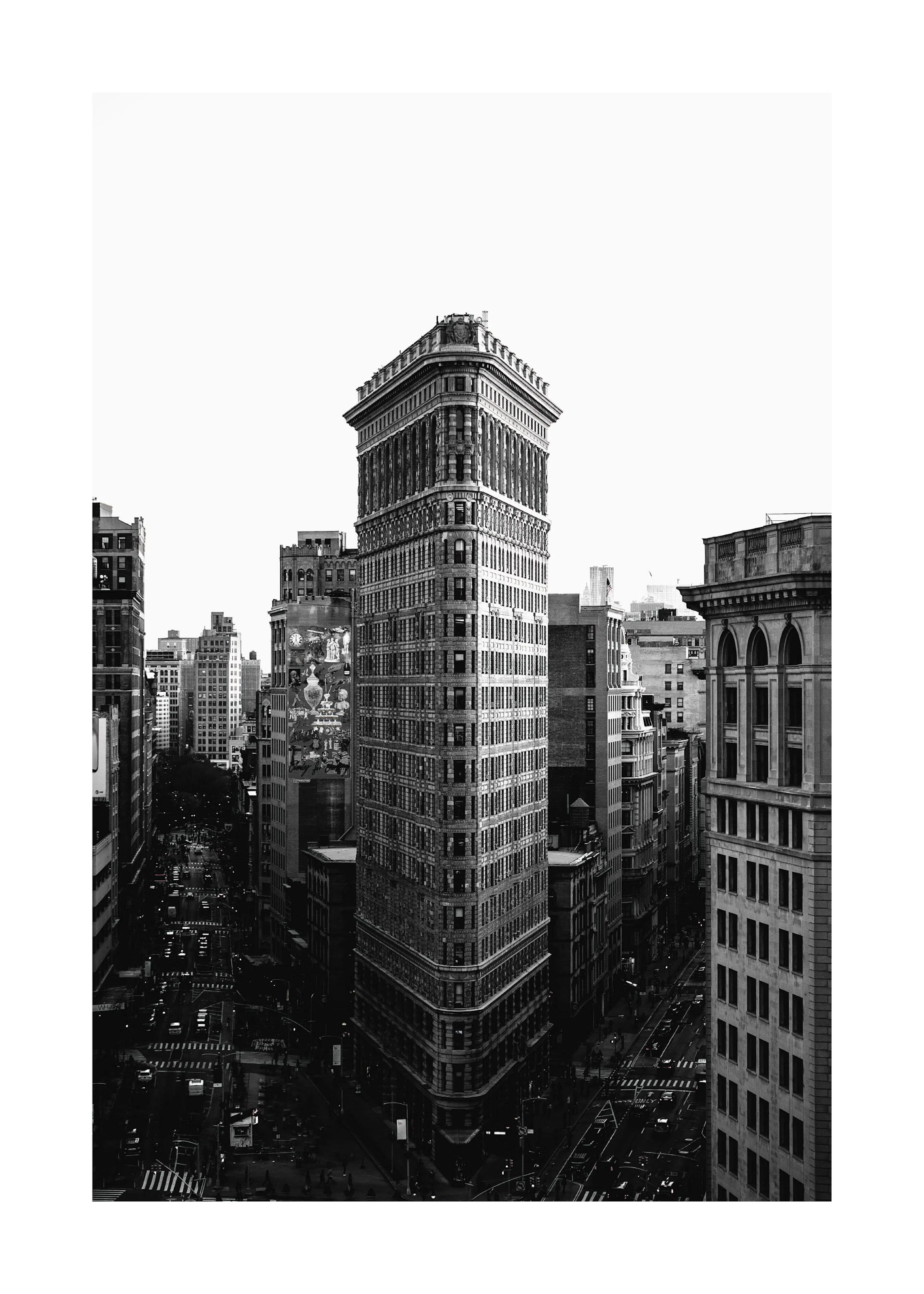 A black and white poster featuring the iconic Flatiron Building in New York City, surrounded by other city architecture.