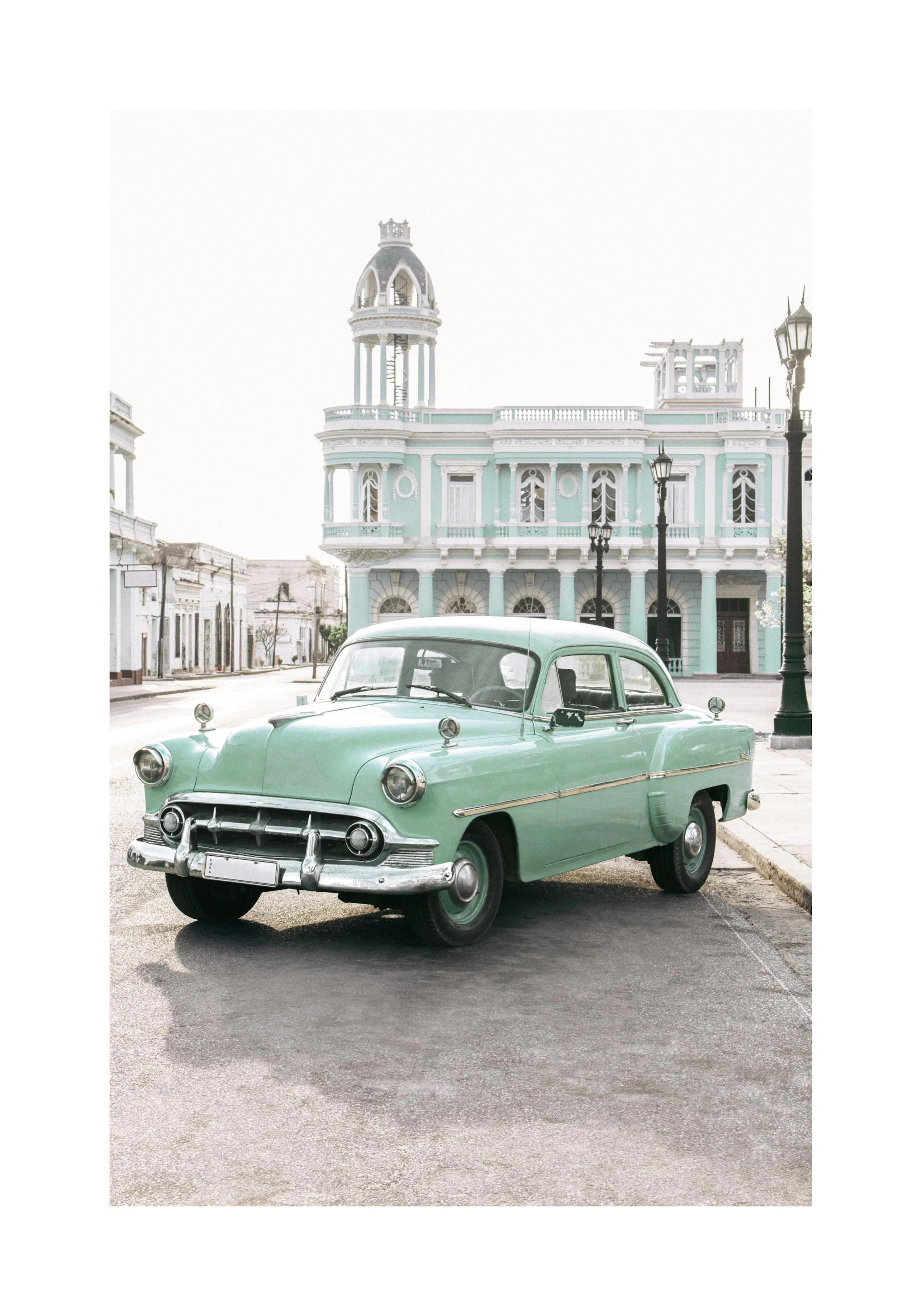 A poster featuring a vintage mint green car parked on a street in front of a grand, light blue building.
