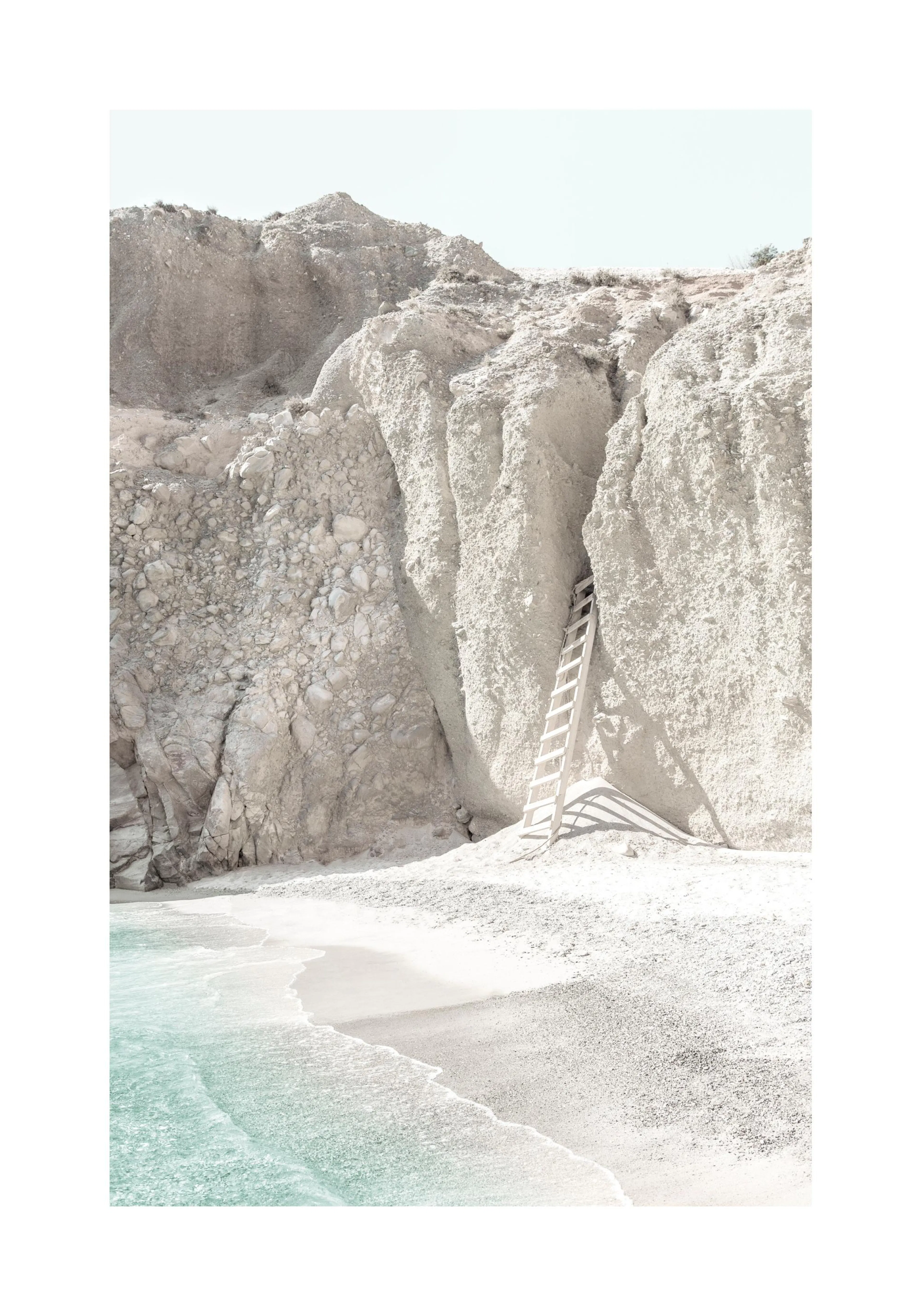 A poster featuring a white wooden ladder leaning against a light beige rocky cliff face next to a calm pale blue ocean and sandy