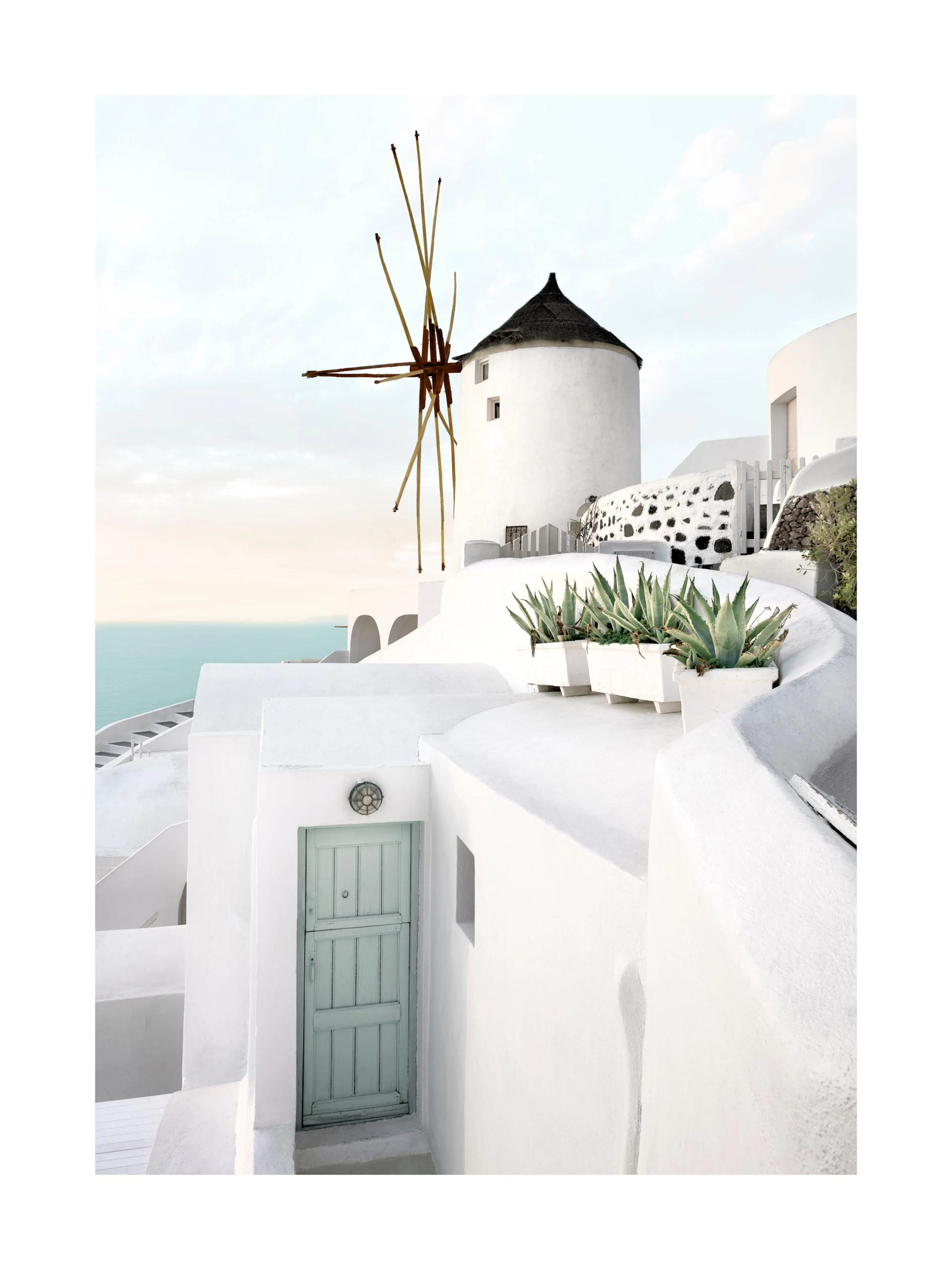 A poster featuring a white windmill with a thatched roof overlooking the sea on a Greek island.