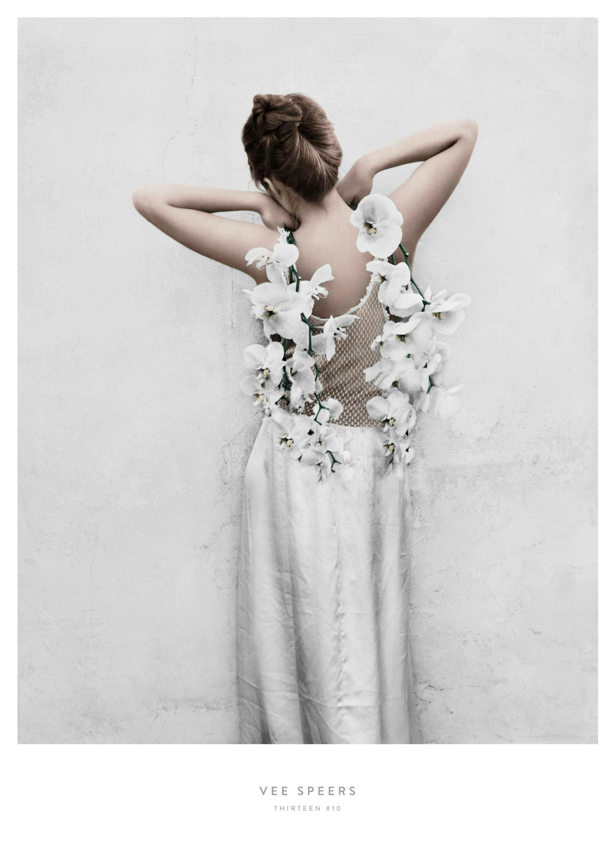 Ein Poster einer Frau von hinten, die ein weisses Kleid mit weissen Blumen trägt, die ihren Rücken bedecken.