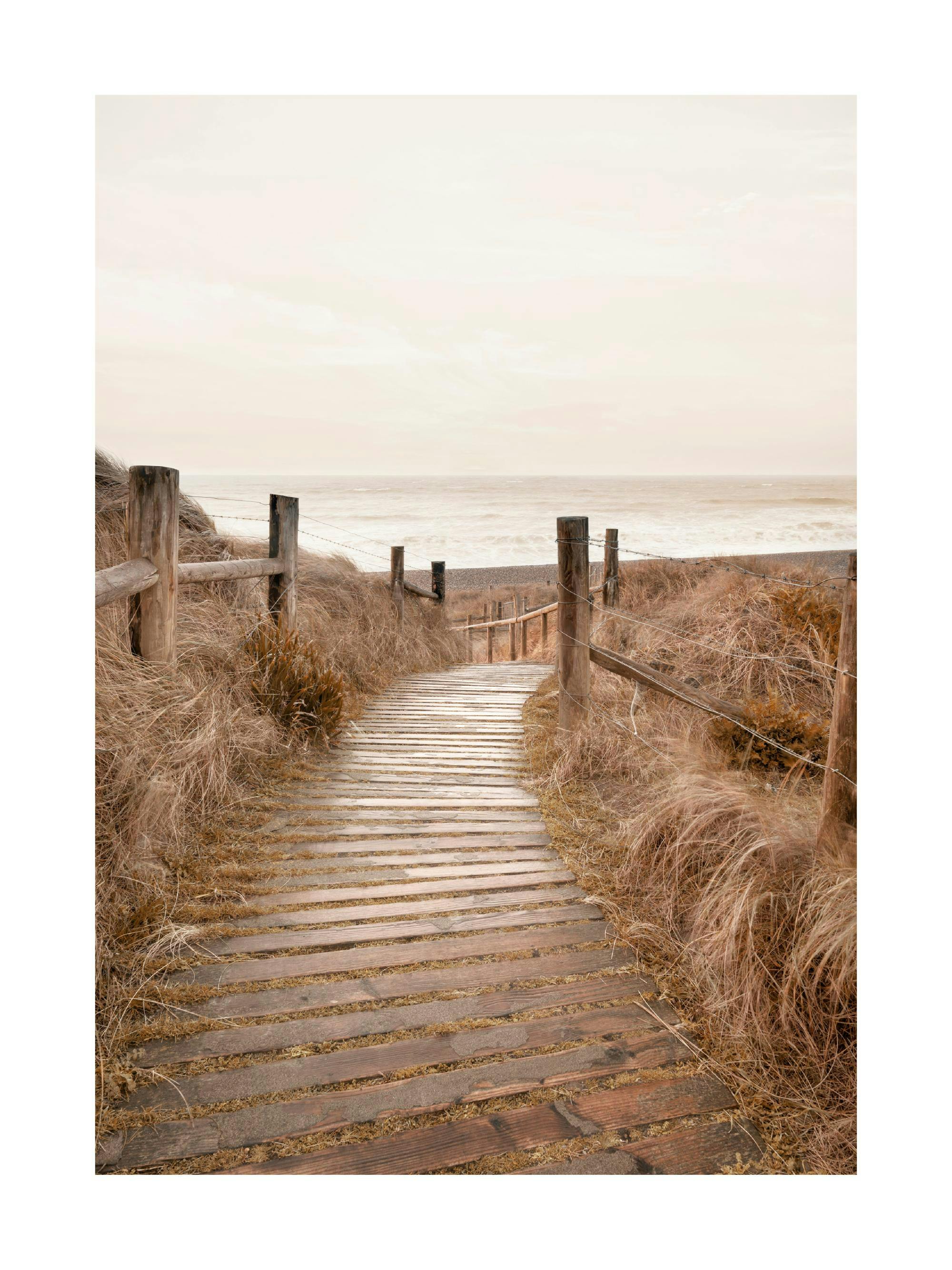 A poster featuring a wooden boardwalk path leading down through tall dry grass to a calm beach and ocean under a light sky.