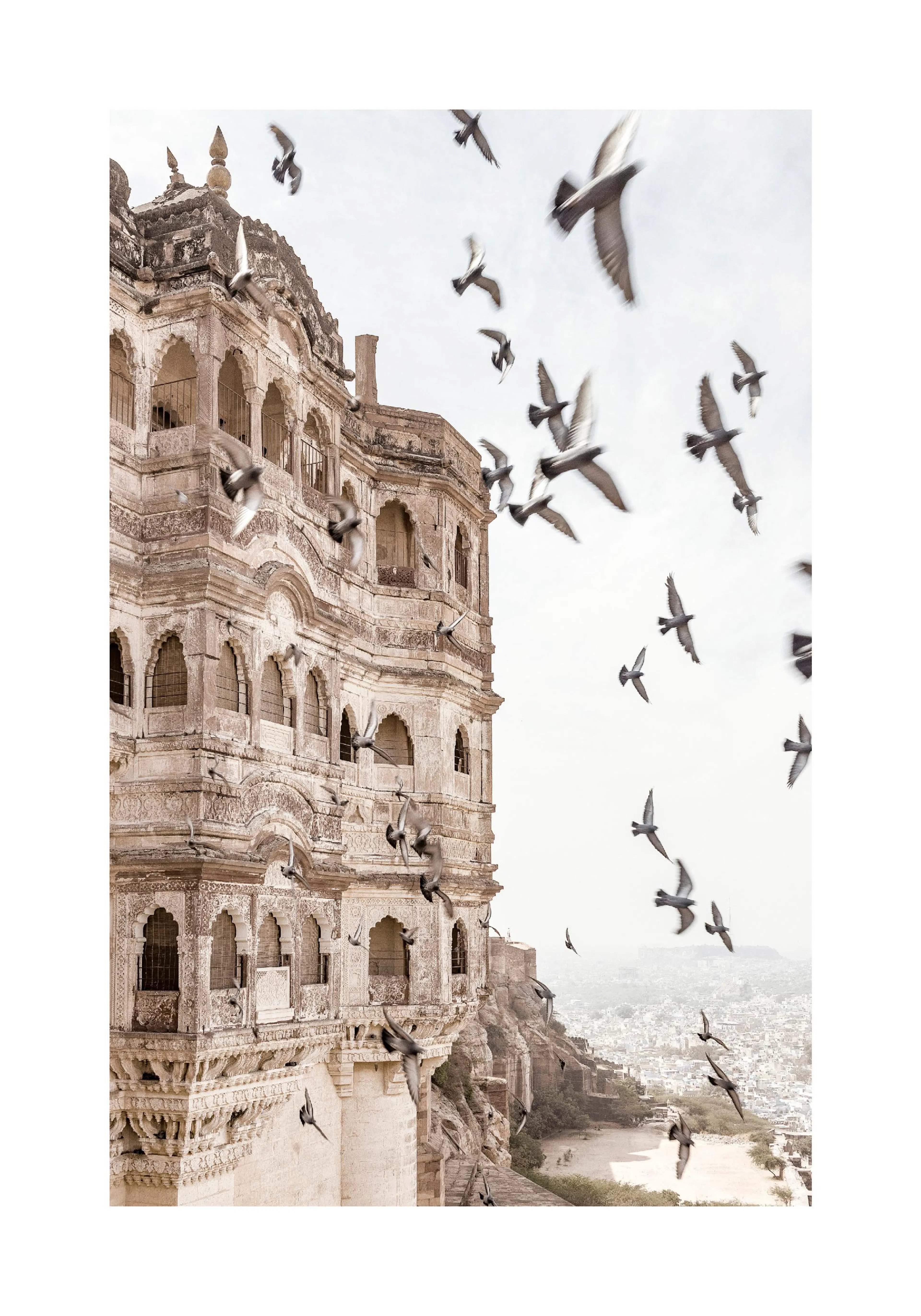 A poster featuring a flock of birds in motion around an ancient, ornate stone building, overlooking a city in the distance.