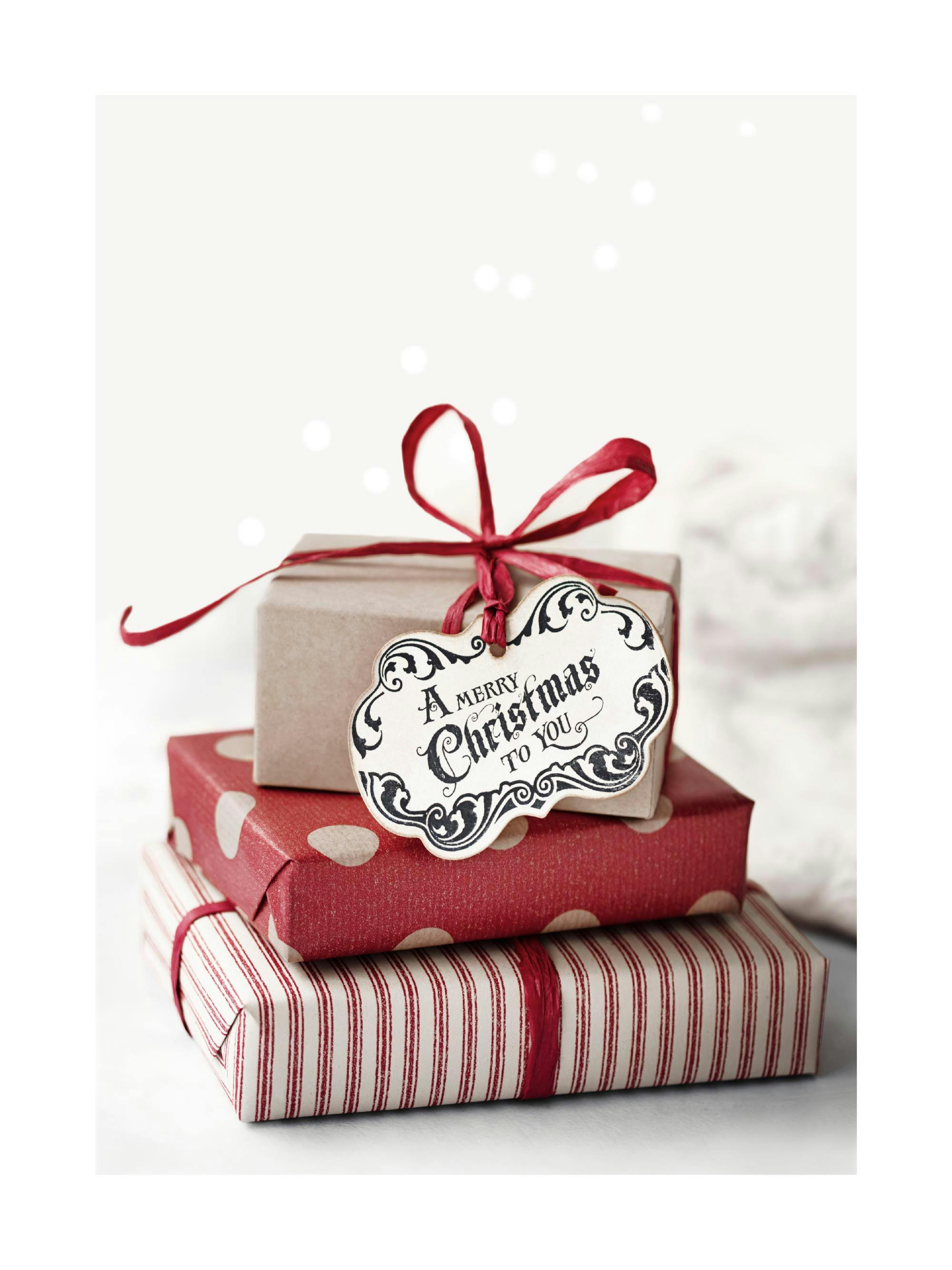 Poster con tre regali di Natale impilati, con fiocchi rossi e cartellino A Merry Christmas To You.