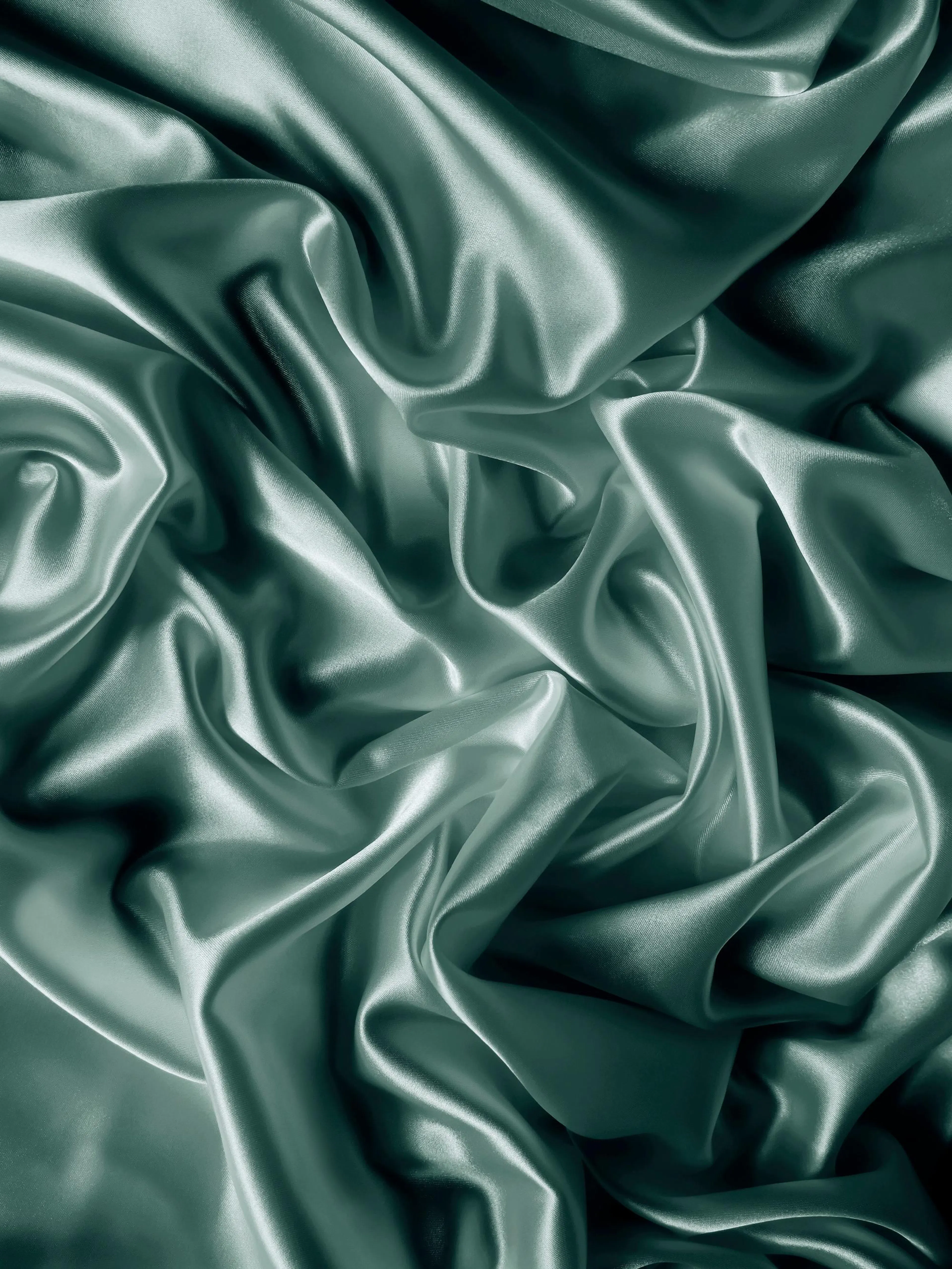 A poster featuring luxurious teal satin fabric with flowing folds and elegant drapes.