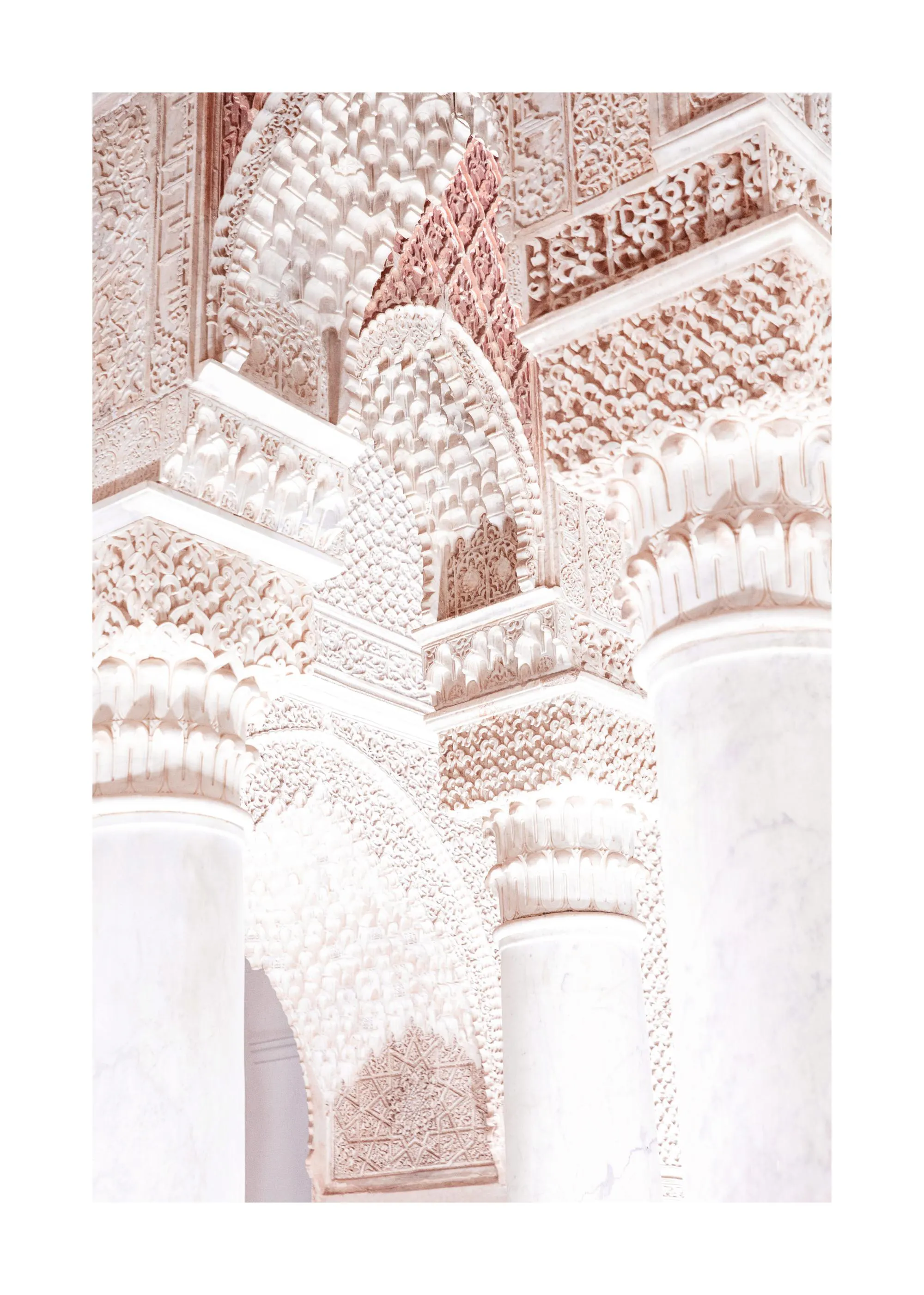 A poster featuring a close-up of intricate light pink and white Moroccan architectural details with carved patterns and arches.