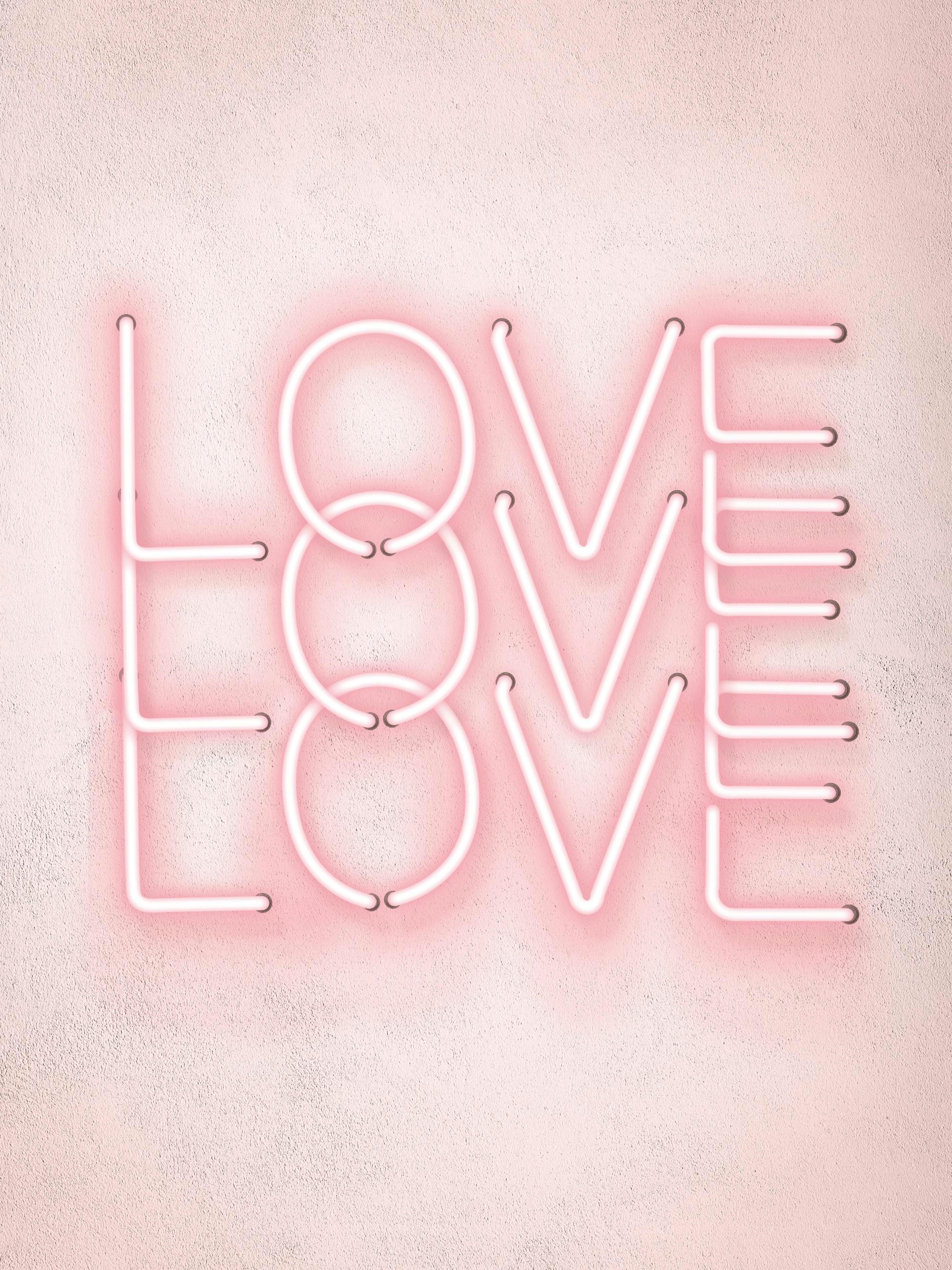 A poster featuring the word LOVE in pink neon lights on a textured light pink background.