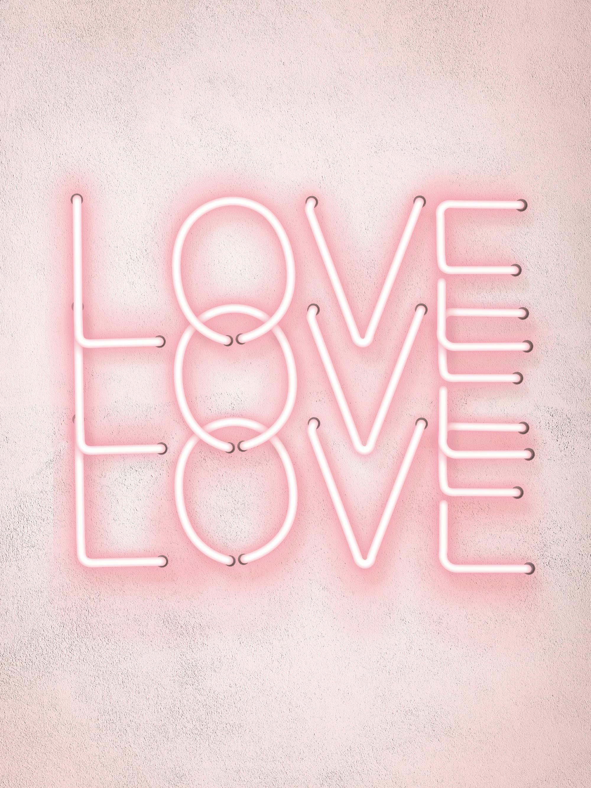 A poster featuring the word LOVE in bright pink neon lights on a textured light pink background.