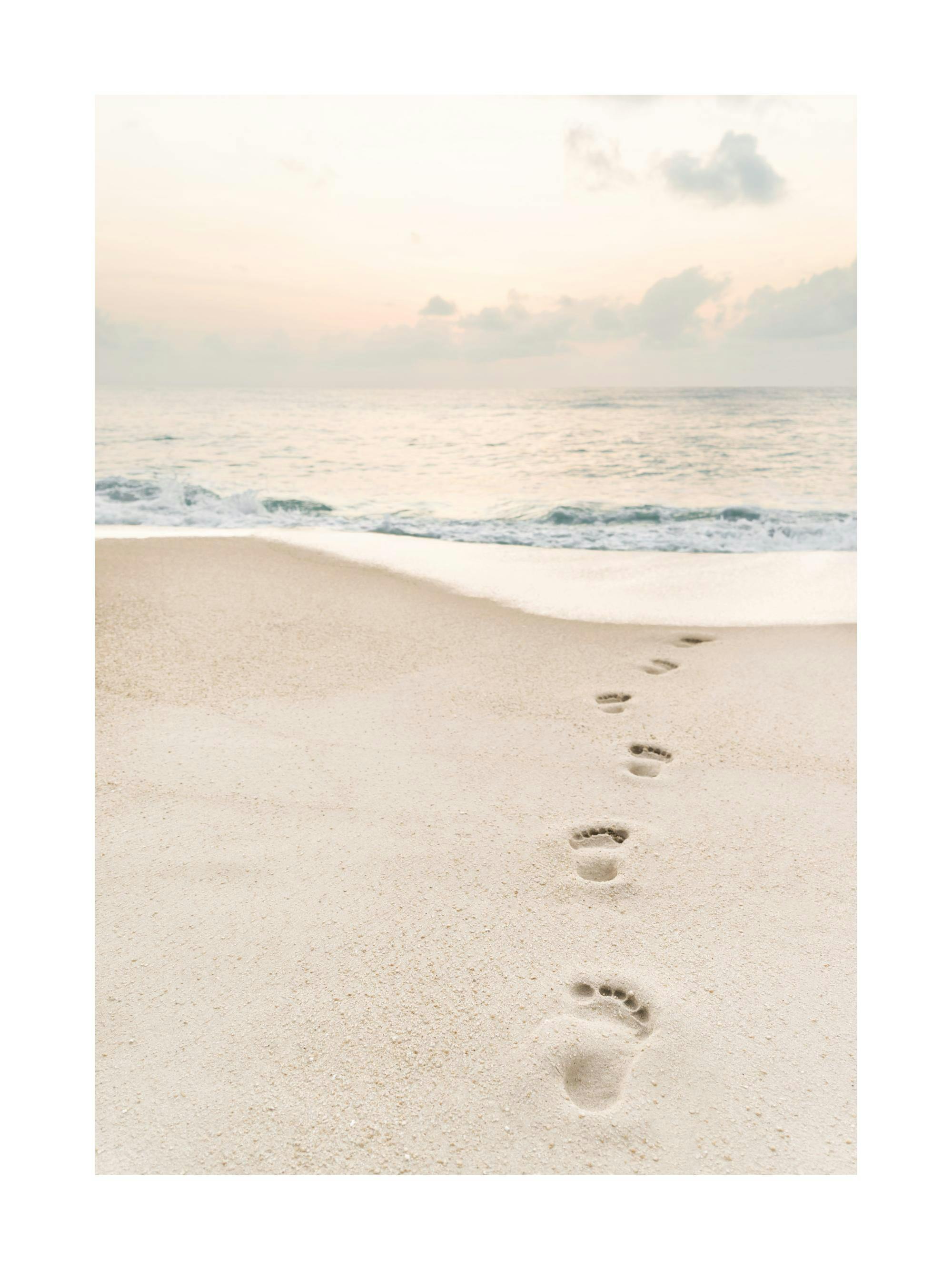 A poster featuring a series of footprints in the beige sand leading towards the ocean under a pale sky.