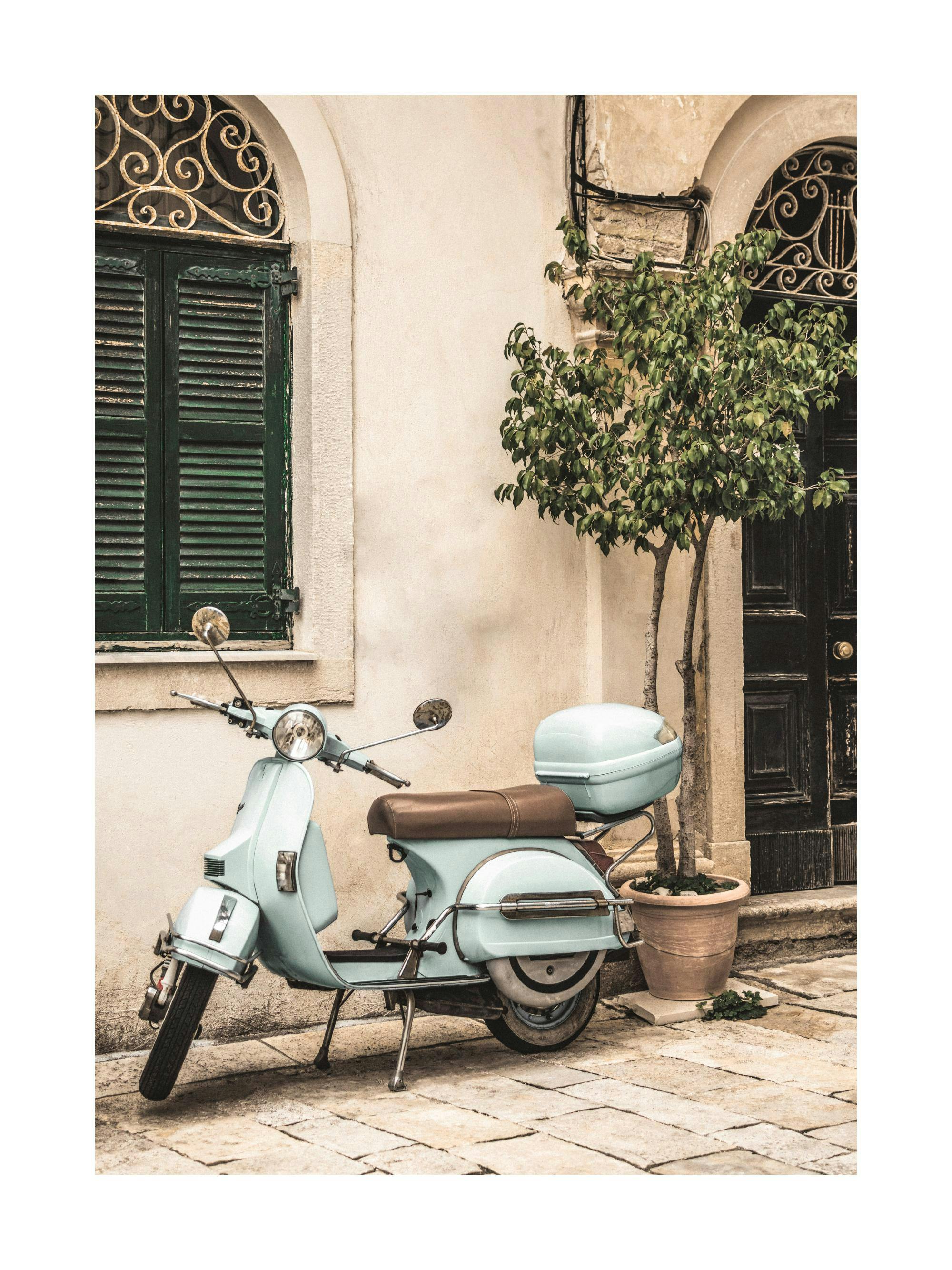 A poster featuring a vintage light blue scooter parked on a cobbled street in front of a building with green wooden shutters.