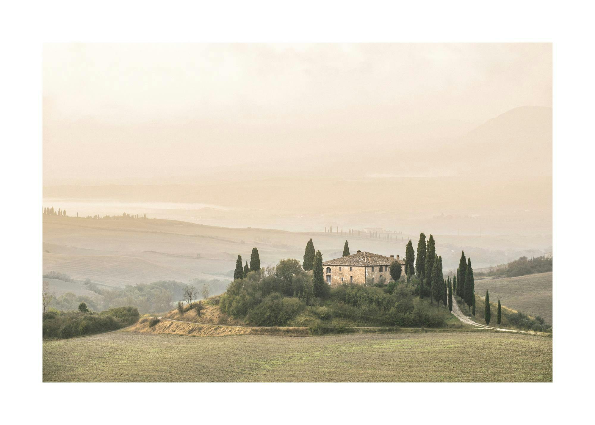 A poster featuring a Tuscan farmhouse surrounded by cypress trees and rolling hills in a hazy morning light.