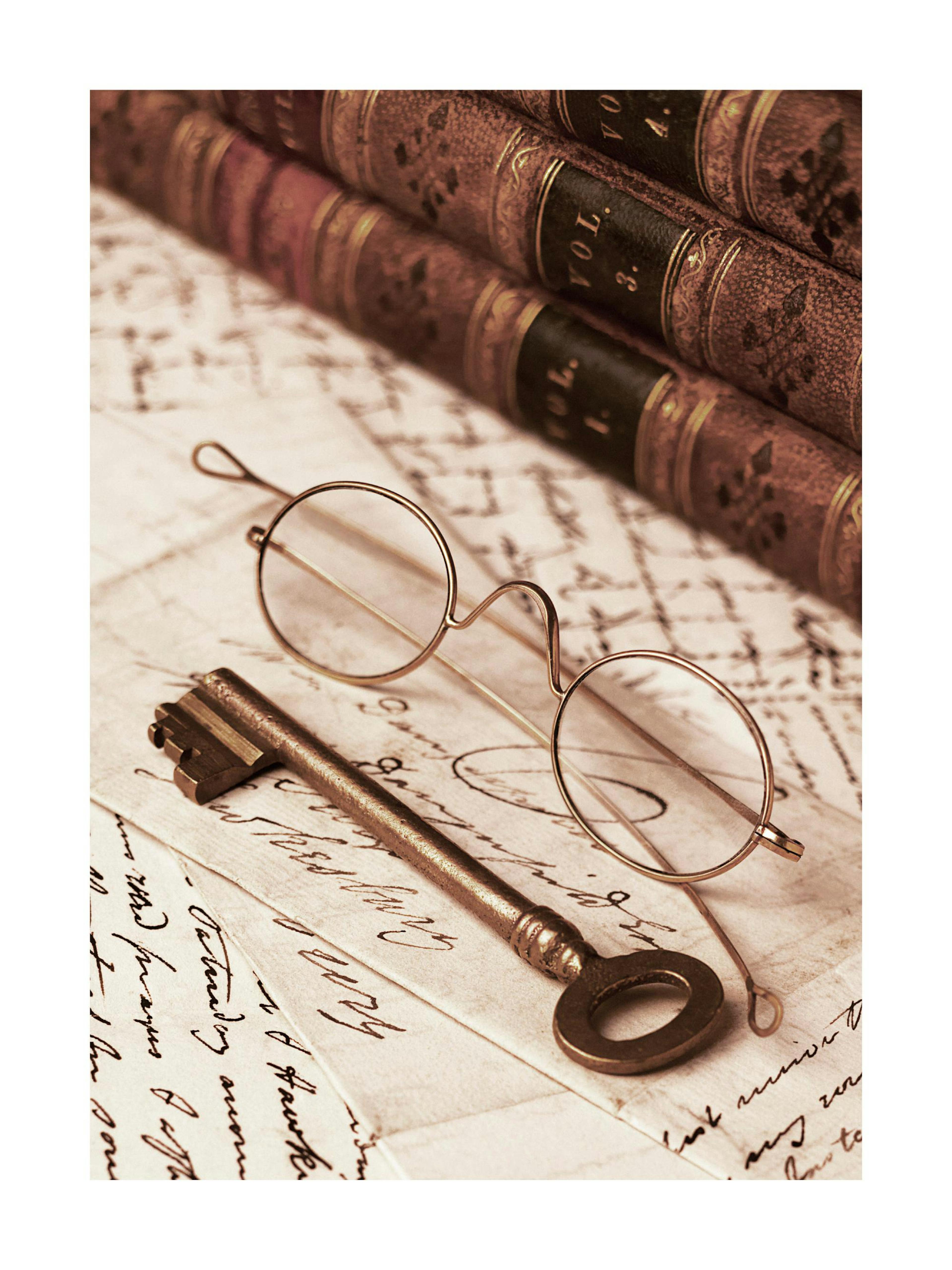 A sepia-toned poster featuring vintage books, an antique key, and round spectacles on old handwritten letters.