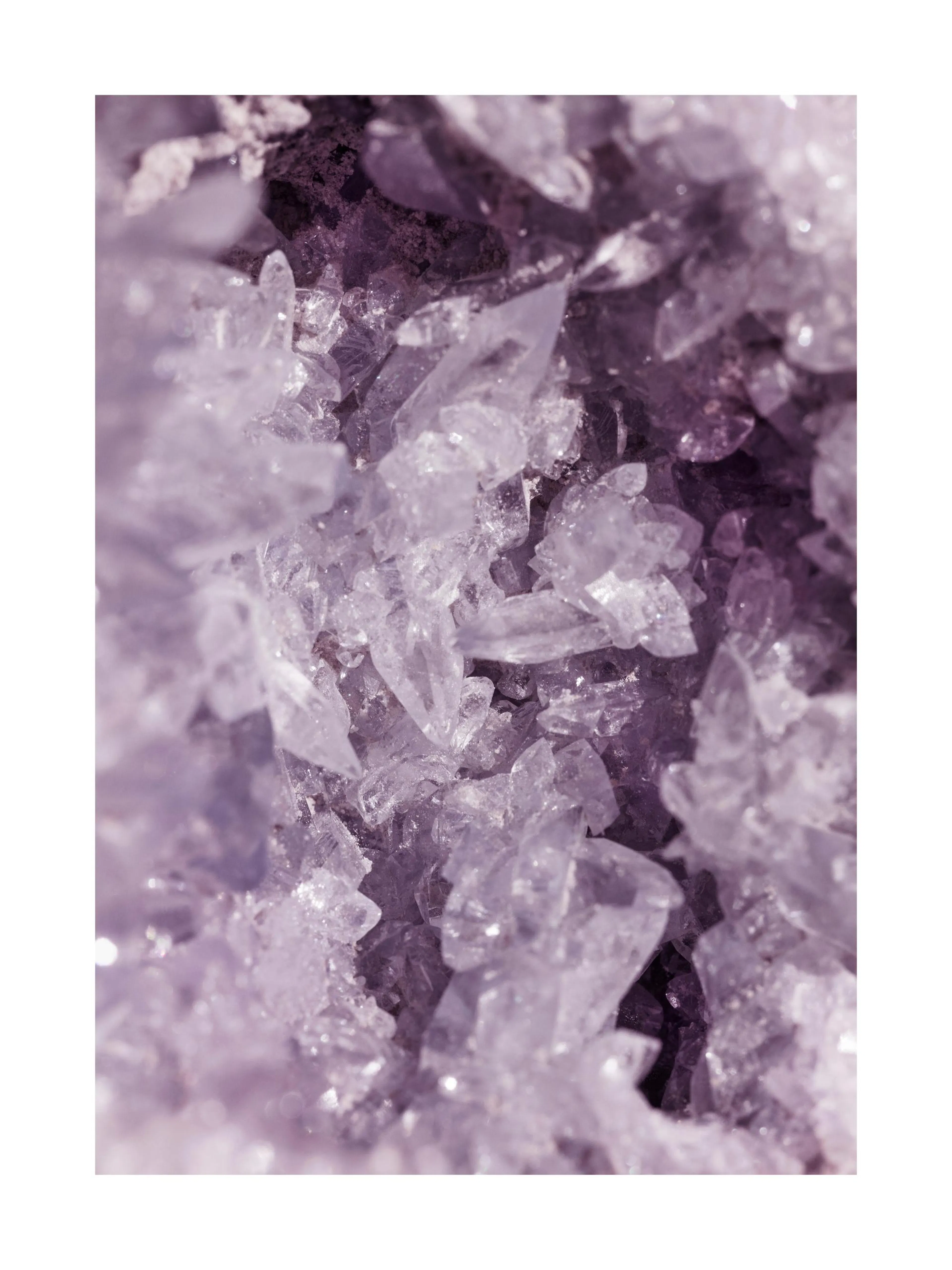 A poster featuring a close-up of sparkling, light purple crystal formations with a dark background.