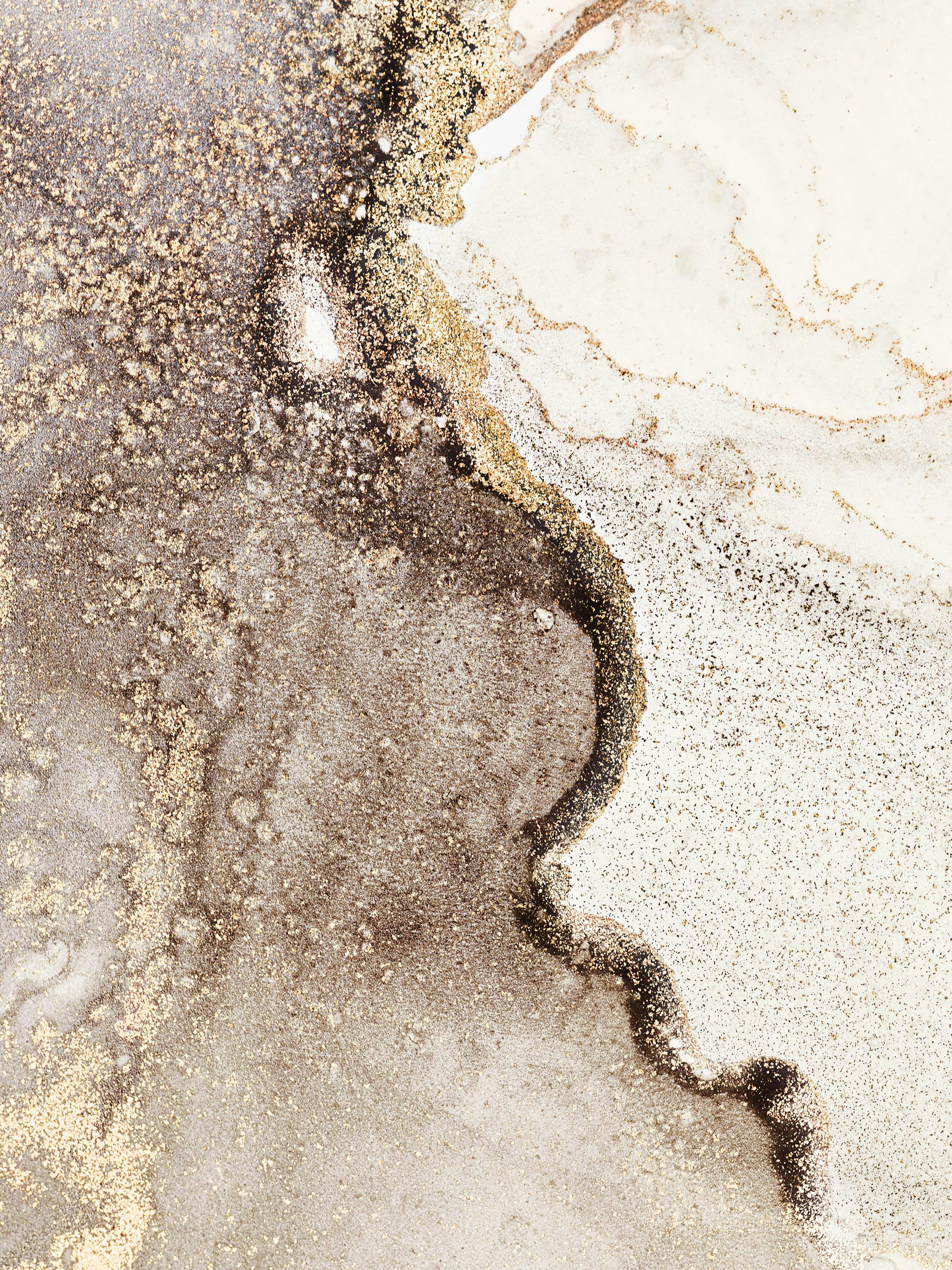 A poster featuring a close-up of a shimmering abstract pattern with gold, black, and white ink flowing together.