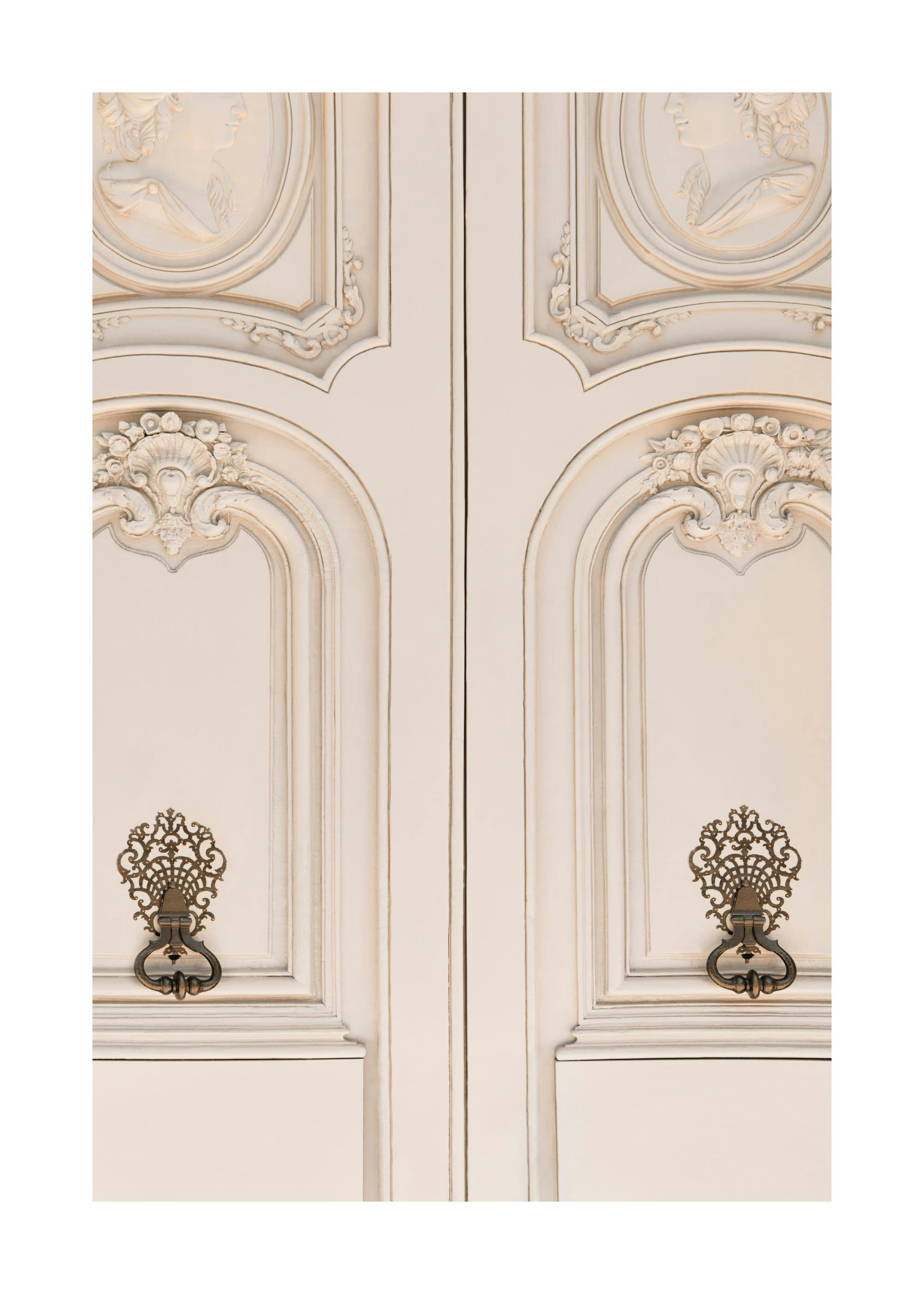 A poster featuring a close-up of an antique white cabinet with decorative carvings and ornate bronze handles.