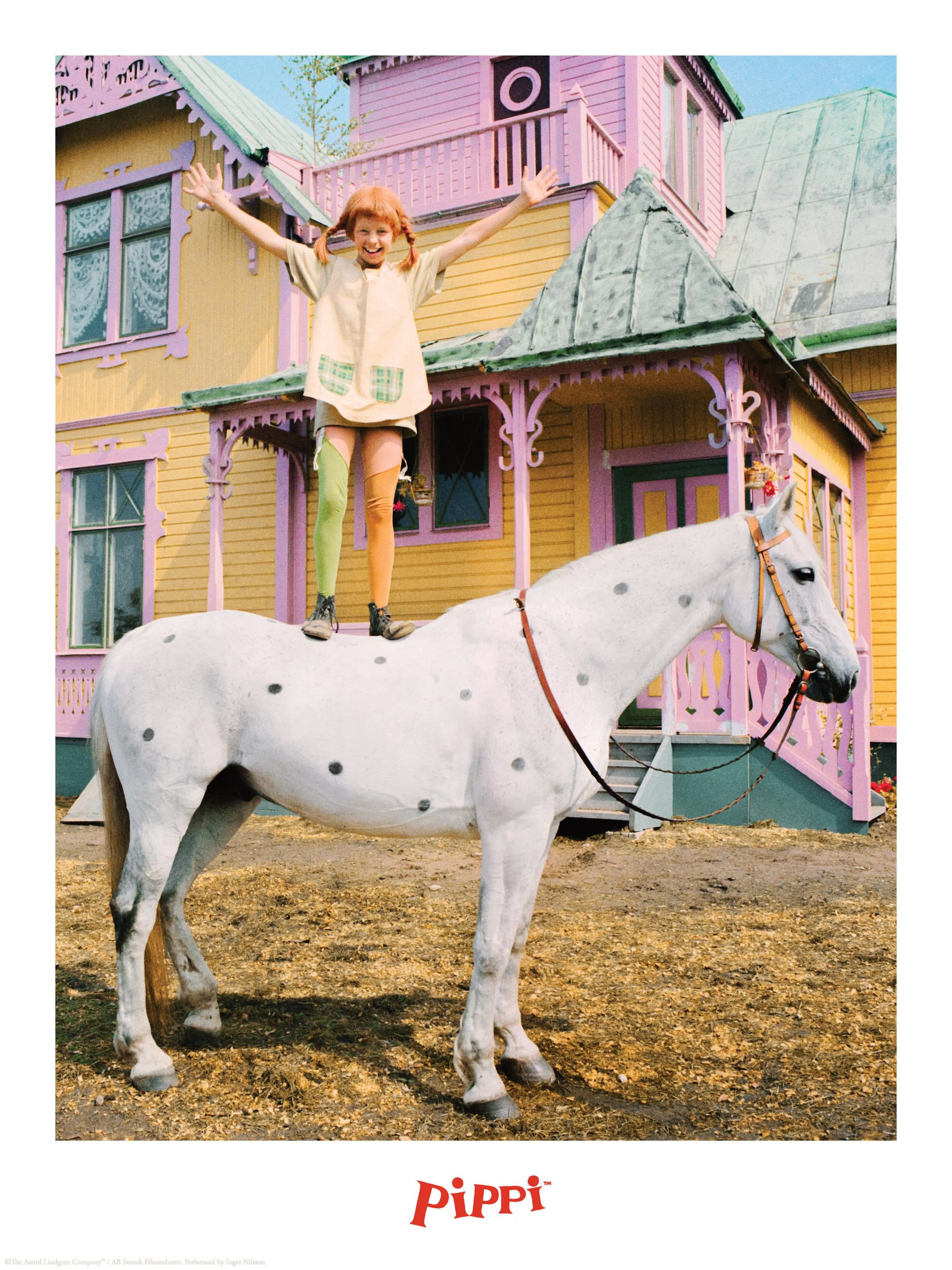 A Pippi Longstocking poster showing Pippi standing on a white horse with black spots in front of a yellow and pink house.