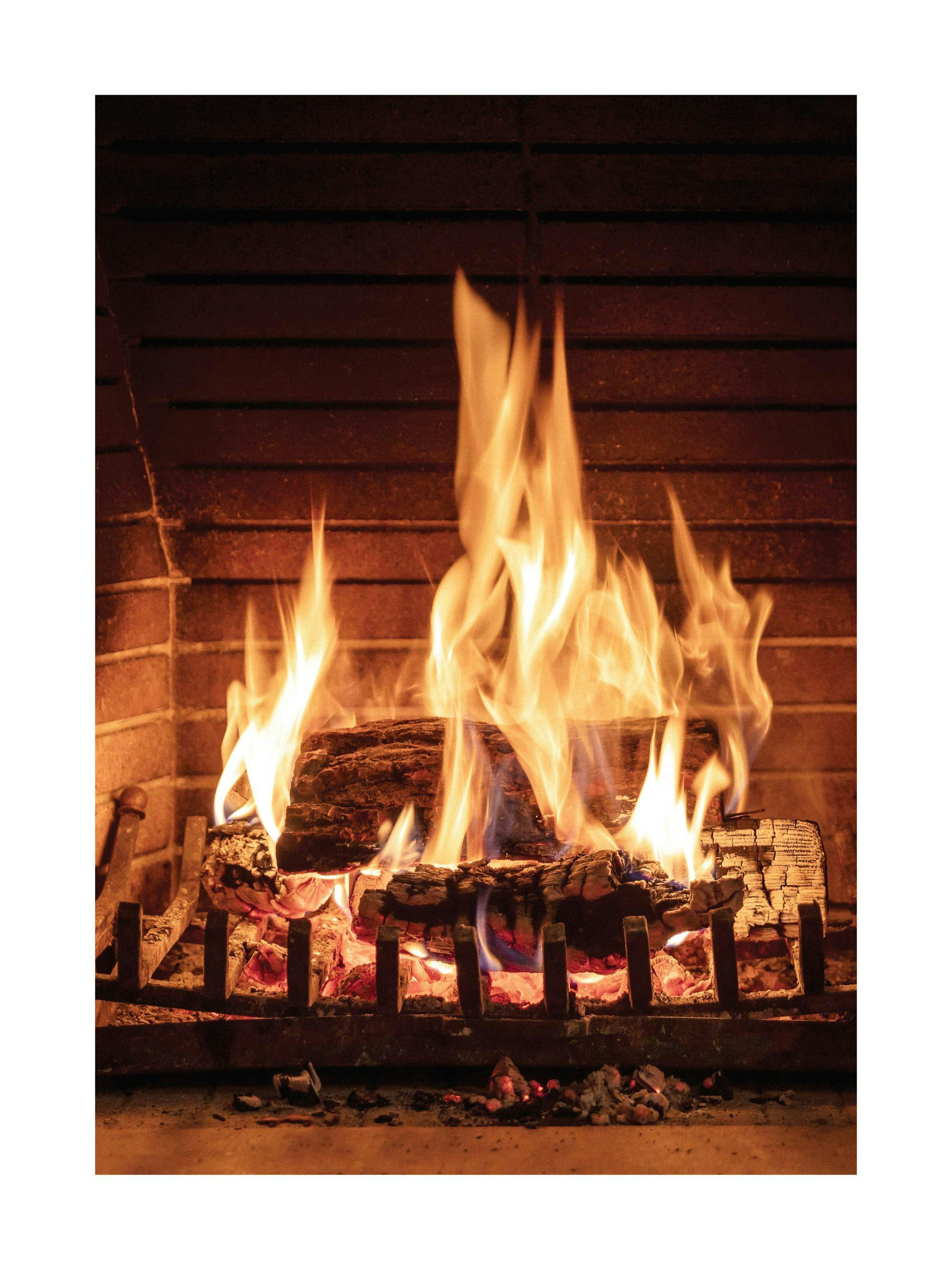 A poster of a crackling fire in a fireplace, with bright orange flames consuming logs and glowing embers.