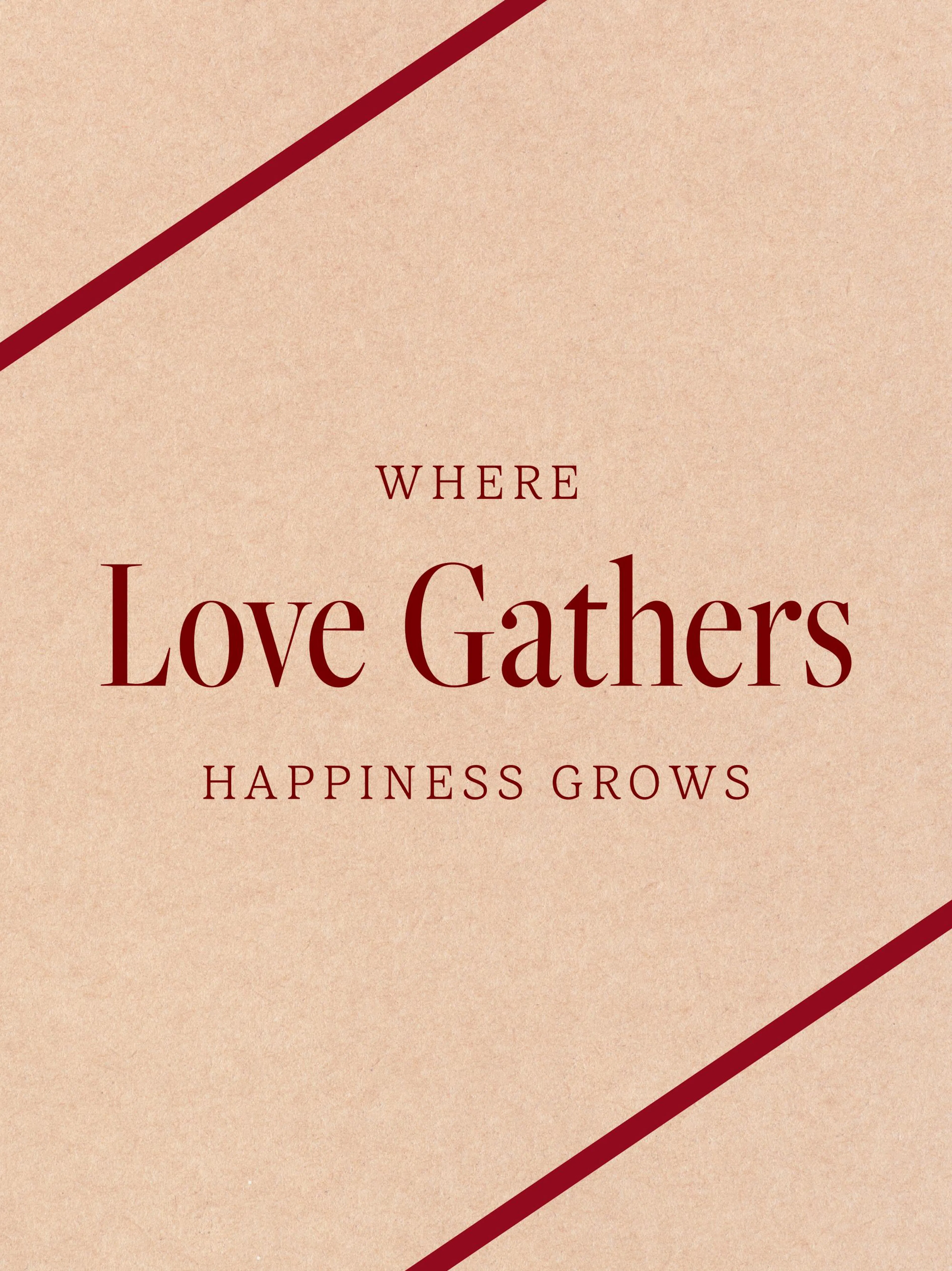 A poster with dark red text WHERE Love Gathers HAPPINESS GROWS on a light brown background with two red diagonal stripes.