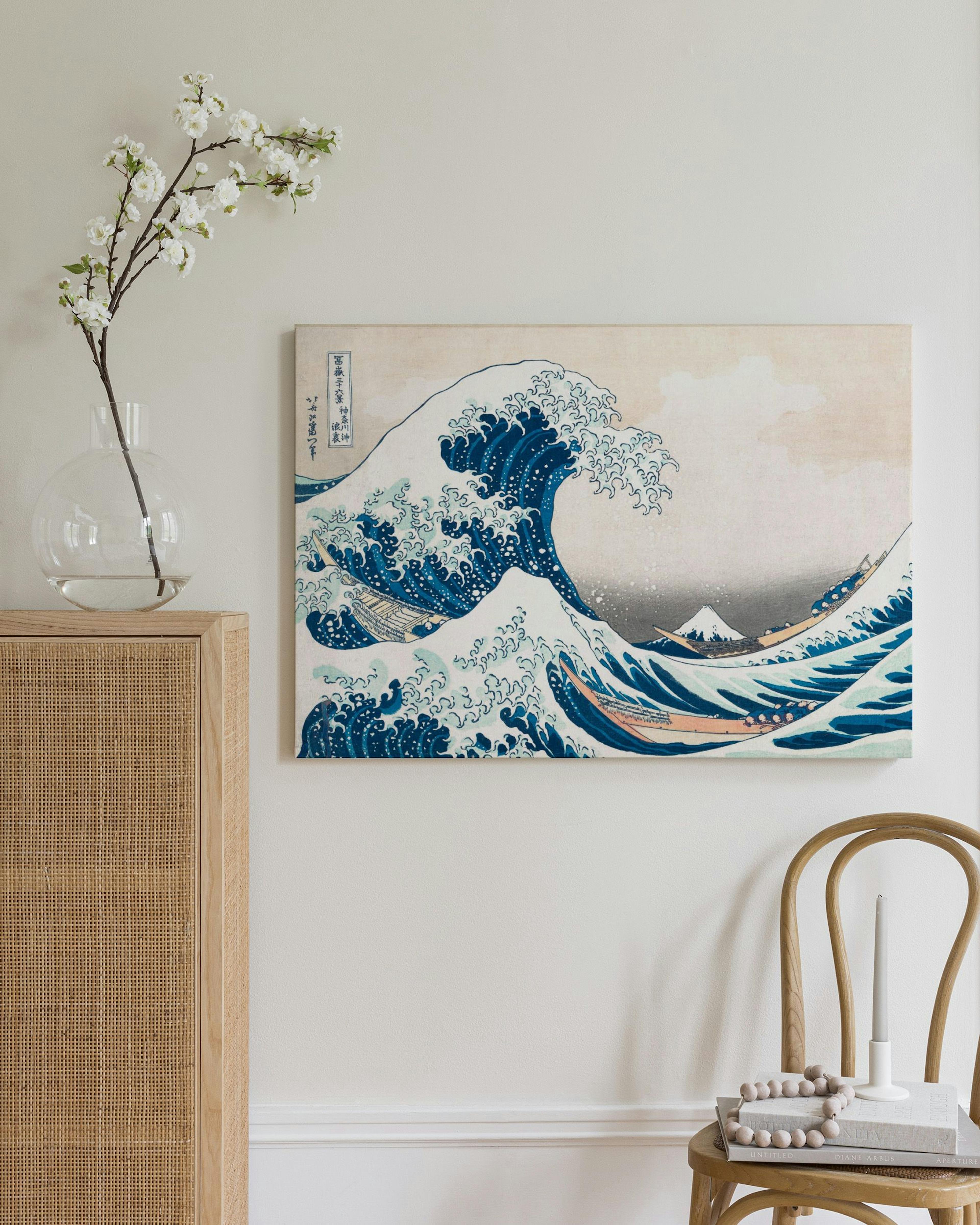 The Great Wave off Kanagawa print by Hokusai, featuring a large blue wave, boats, and Mount Fuji.