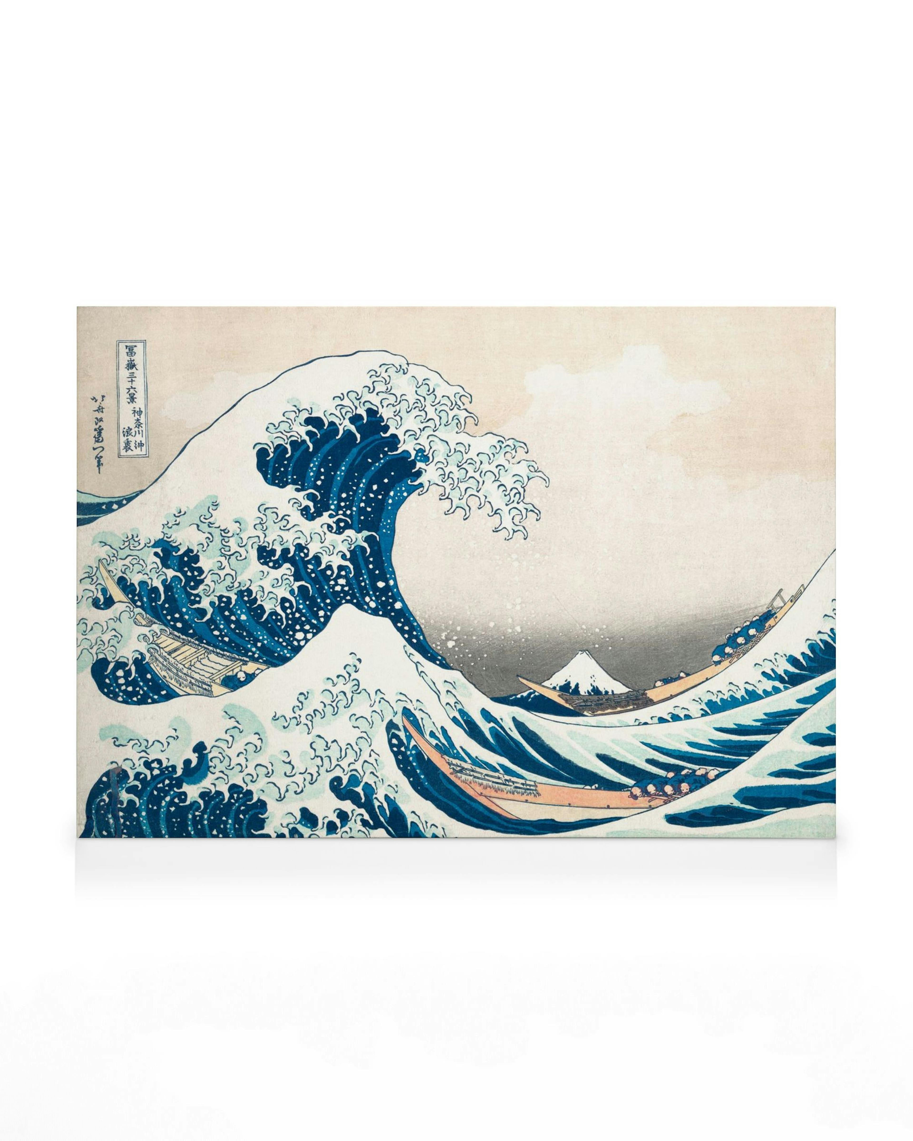 A canvas featuring the Great Wave off Kanagawa by Hokusai, with a large breaking wave, boats, and Mount Fuji.