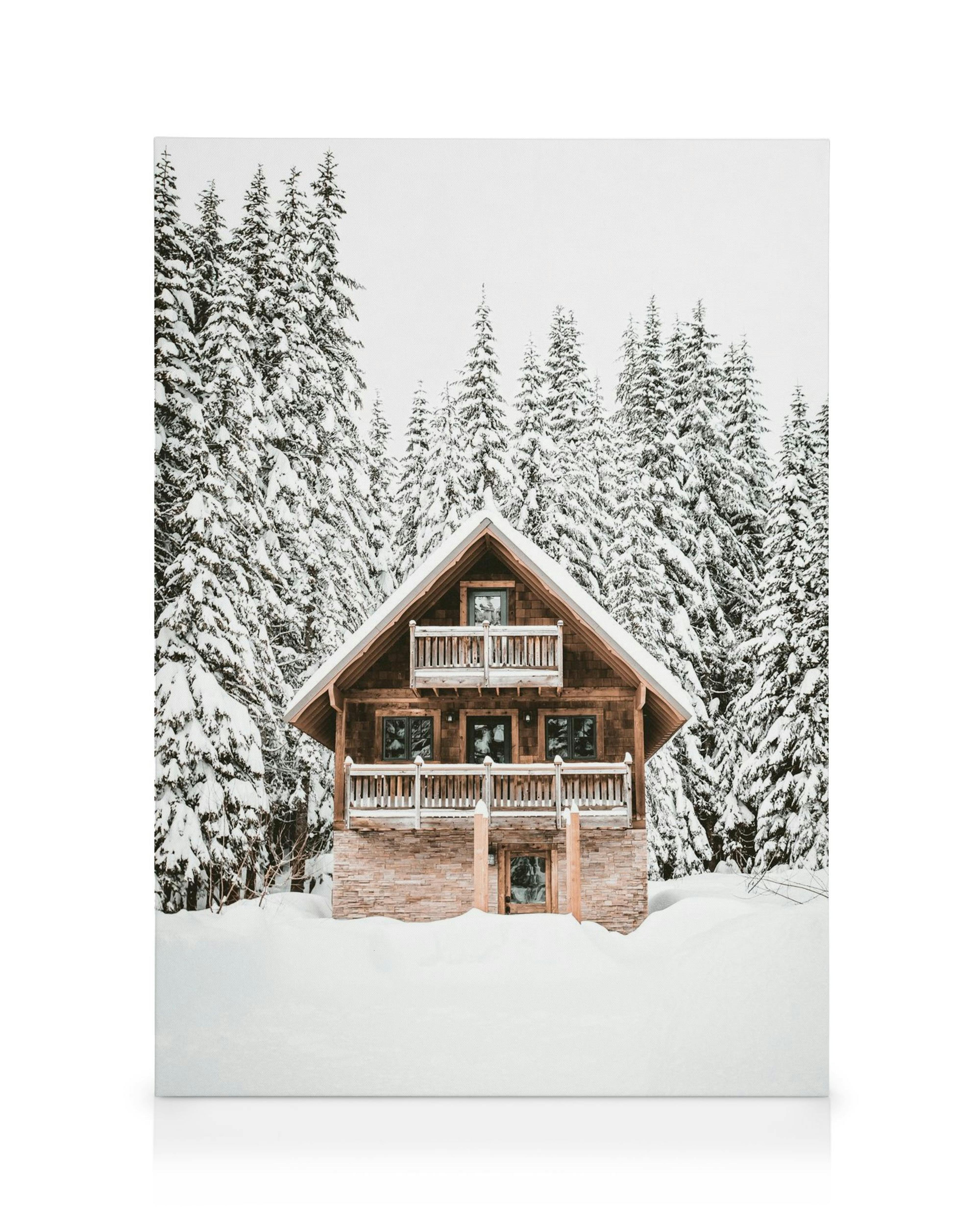 A stunning canvas showcasing a snow-covered chalet nestled among pristine pine trees in a winter landscape.